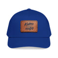 Vintage-inspired baseball cap featuring a brown leather patch with the phrase “Kindness Changes Everything” on a structured mid-profile snapback hat.