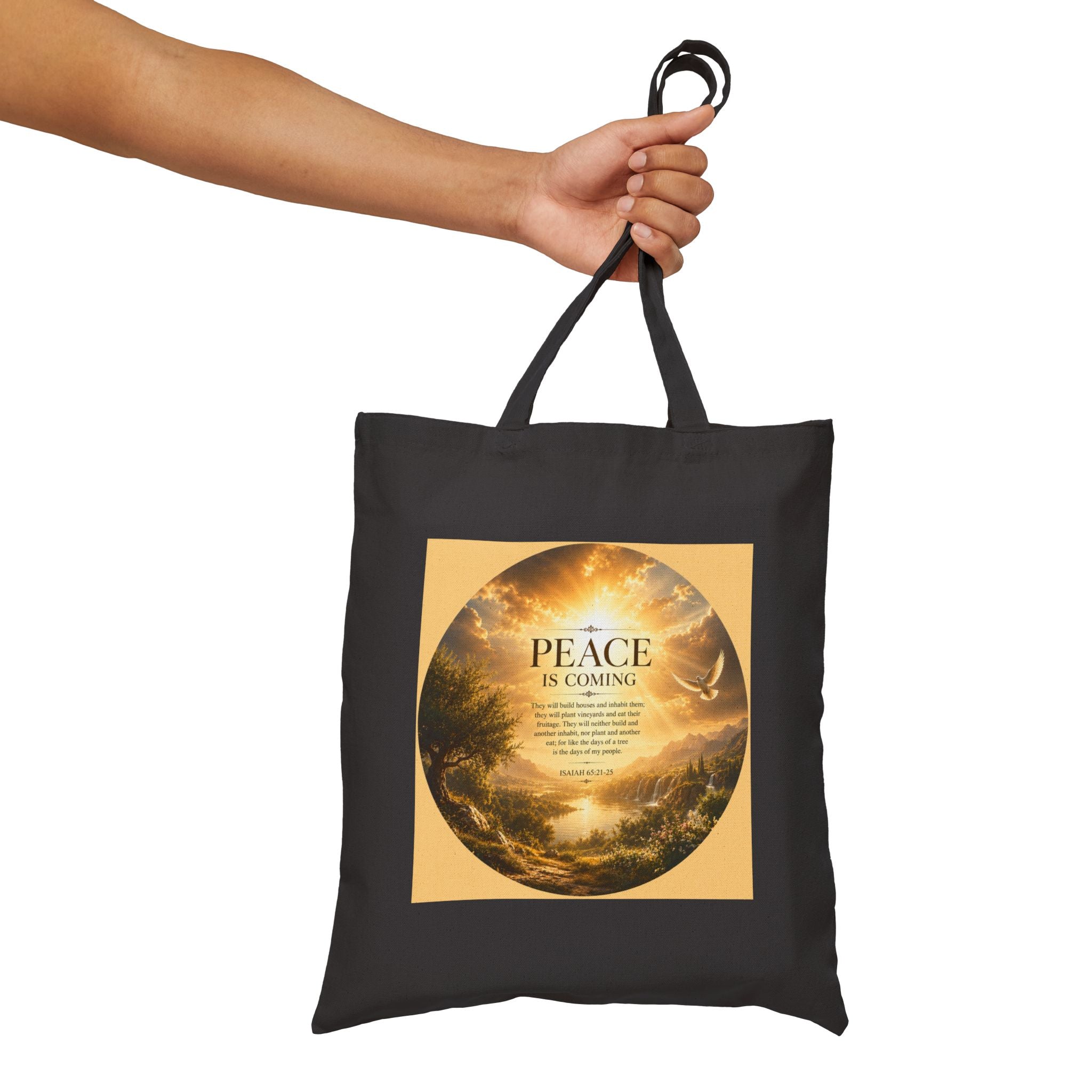 Christian cotton canvas tote bag featuring Isaiah 65:21-25 and the message “Peace Is Coming,” with golden paradise landscape artwork, waterfalls, mountains, river, white dove, and radiant sunlight.
