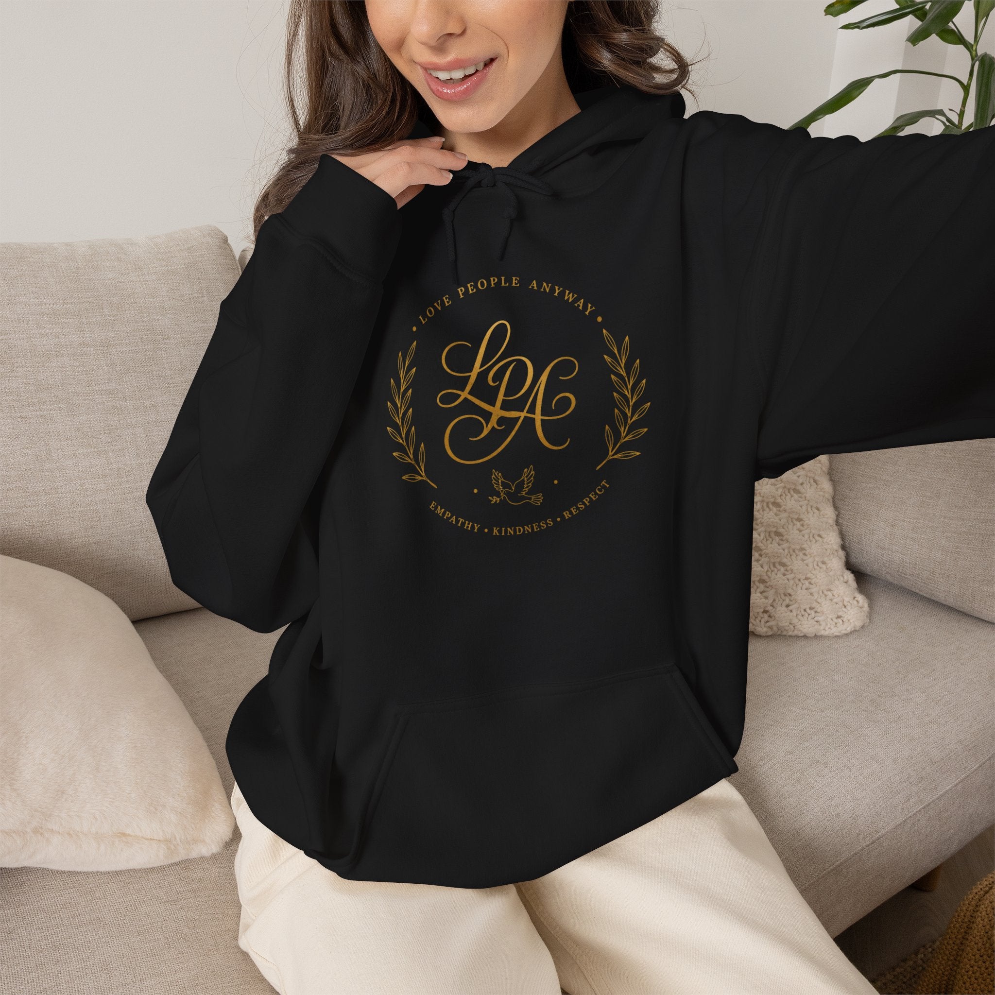 Inspirational Christian hoodie featuring elegant “Love People Anyway” script typography on a soft, cozy hooded sweatshirt designed to encourage kindness and compassion.
