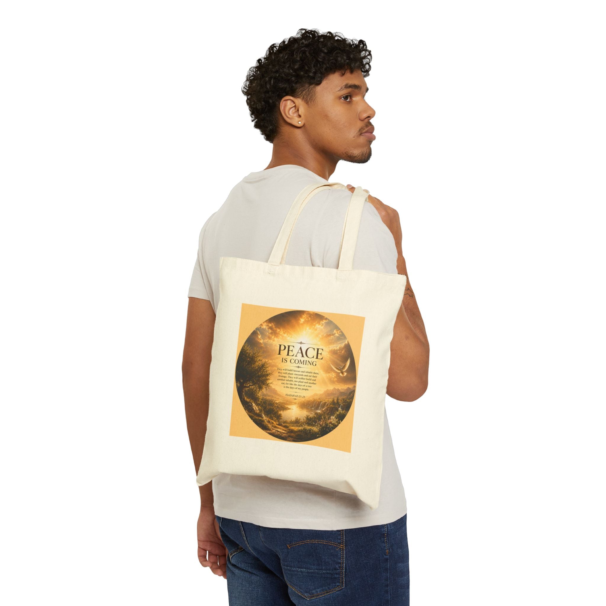 Christian cotton canvas tote bag featuring Isaiah 65:21-25 and the message “Peace Is Coming,” with golden paradise landscape artwork, waterfalls, mountains, river, white dove, and radiant sunlight.