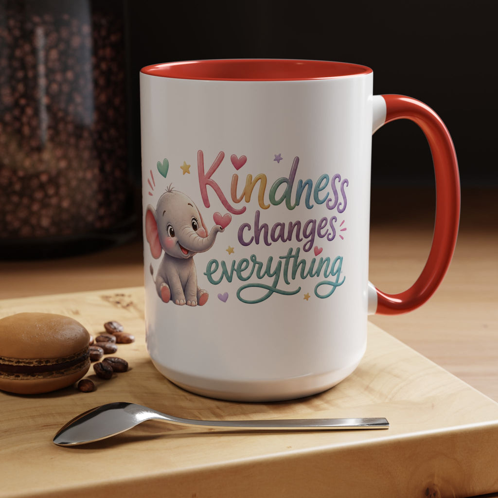 Cute ceramic coffee mug featuring a pastel baby elephant and the uplifting message “Kindness Changes Everything” with colorful accent handle and interior.