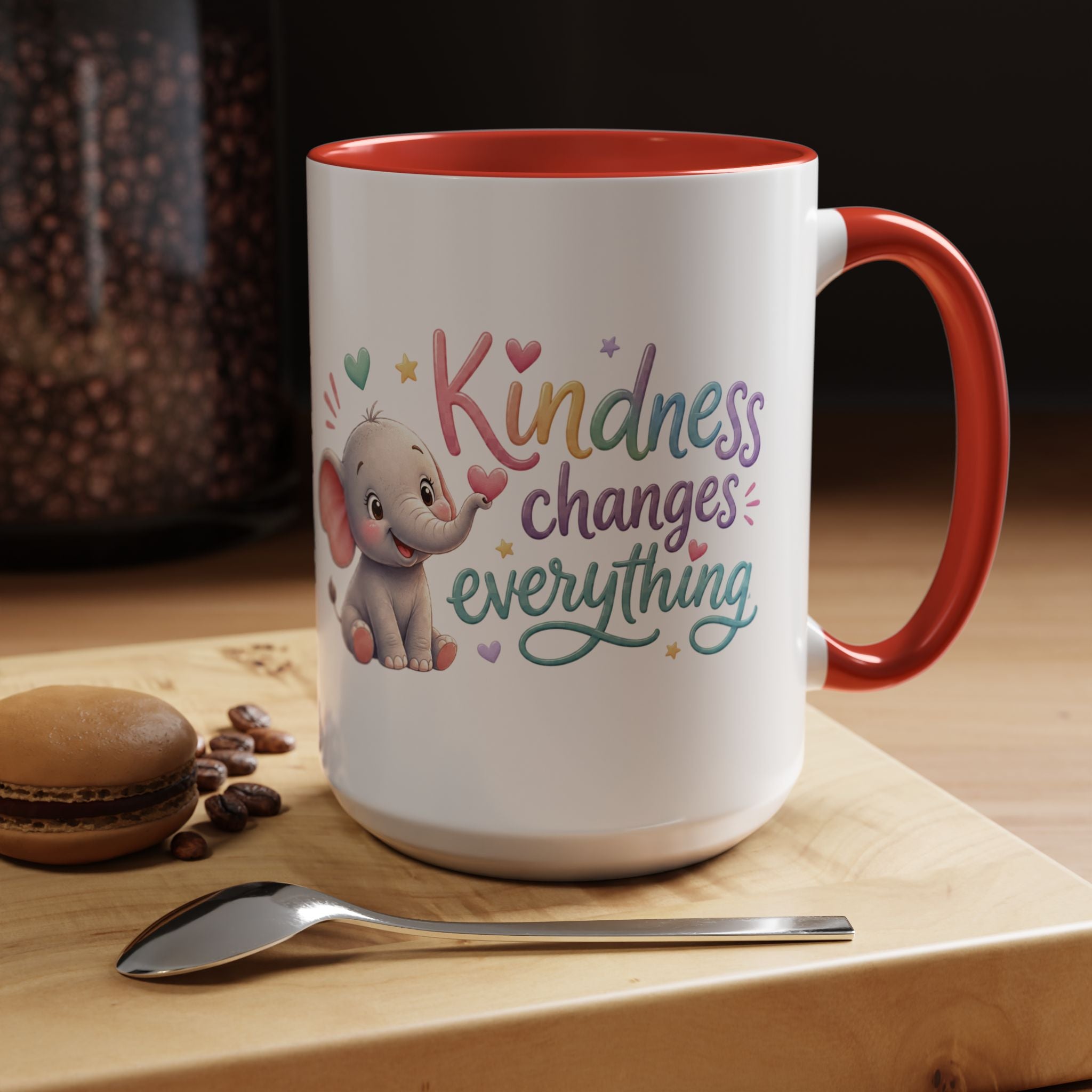 Cute ceramic coffee mug featuring a pastel baby elephant and the uplifting message “Kindness Changes Everything” with colorful accent handle and interior.