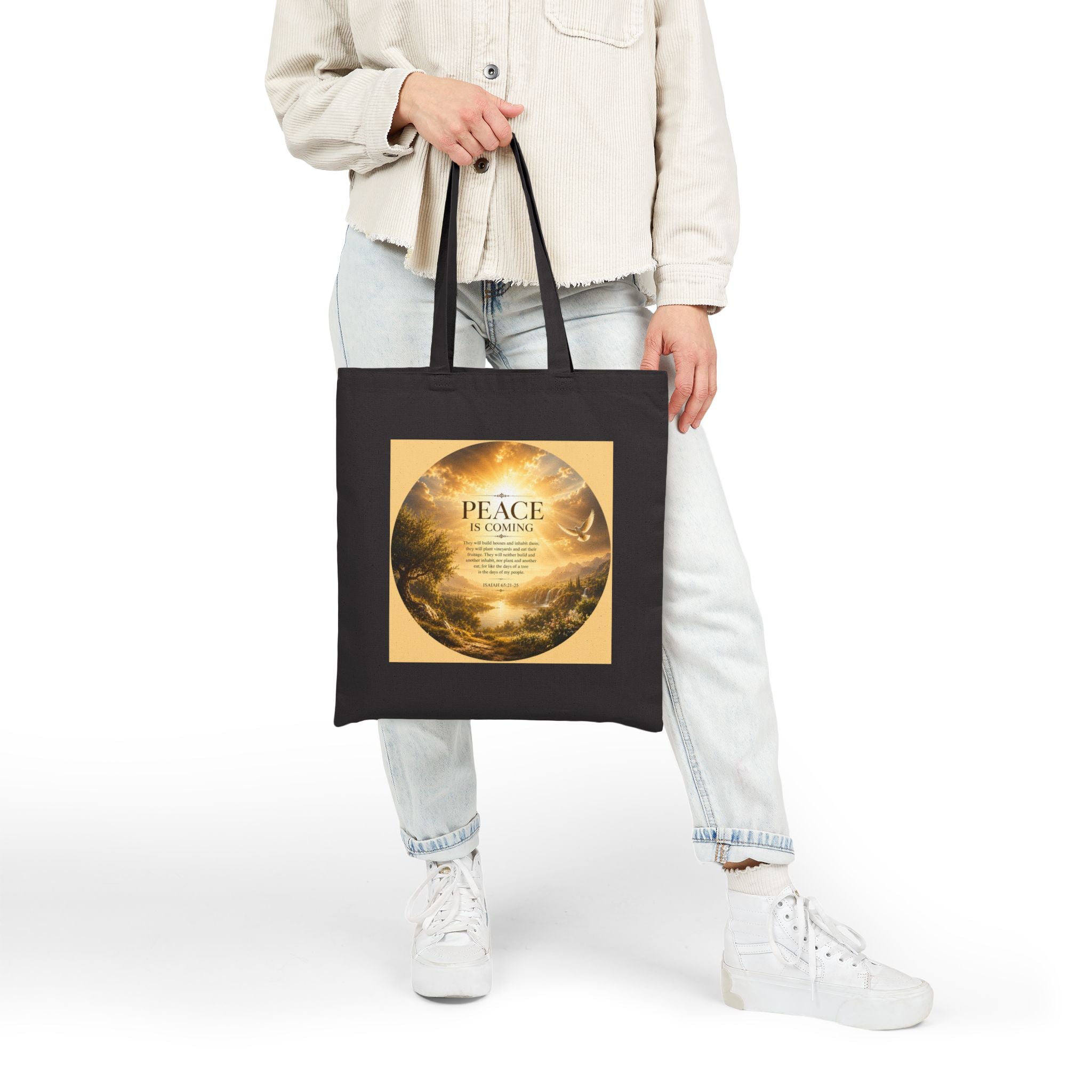 Christian cotton canvas tote bag featuring Isaiah 65:21-25 and the message “Peace Is Coming,” with golden paradise landscape artwork, waterfalls, mountains, river, white dove, and radiant sunlight.