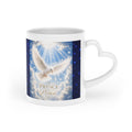 White ceramic heart-shaped handle mug featuring a radiant white dove beneath the words "Prince of Peace" on a deep midnight-blue starry sky background.