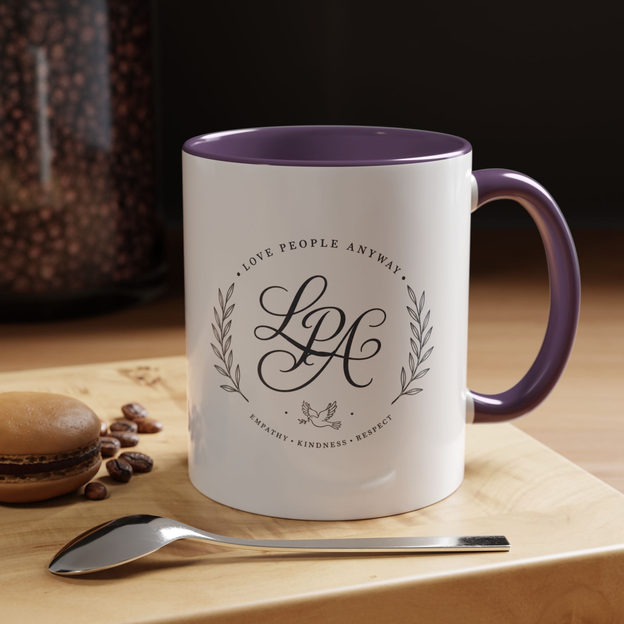 Personalized ceramic accent coffee mug featuring a custom monogram crest and the inspirational message “Love People Anyway” with colorful handle and interior accents.