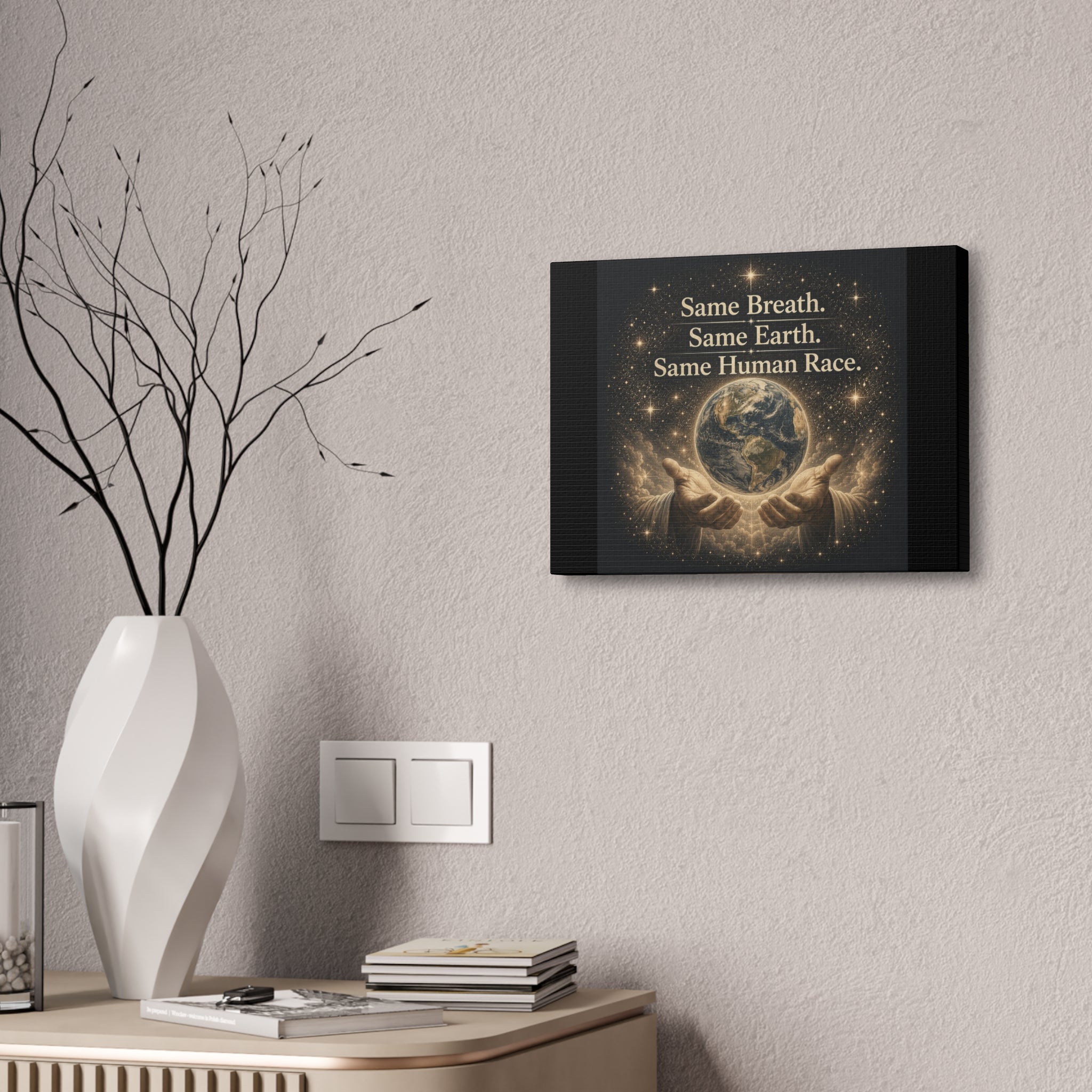 Inspirational canvas wall art featuring the earth held in gentle hands surrounded by glowing stars with the quote “Same Breath. Same Earth. Same Human Race.” in warm golden tones.
