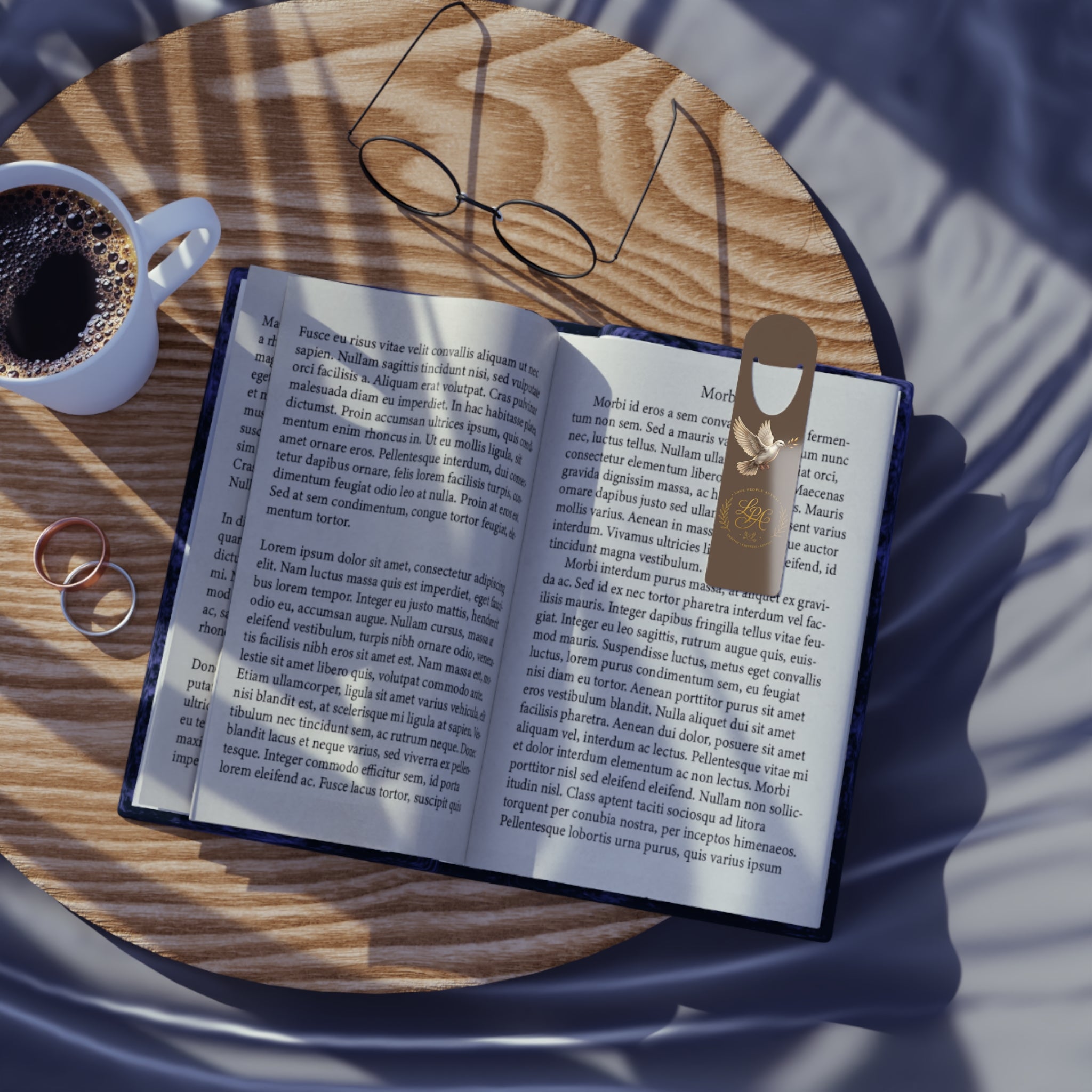 Personalized aluminum bookmark featuring a dove, laurel wreath, and custom monogram on a warm brown background with brushed metal backing and secure page-holding slot.