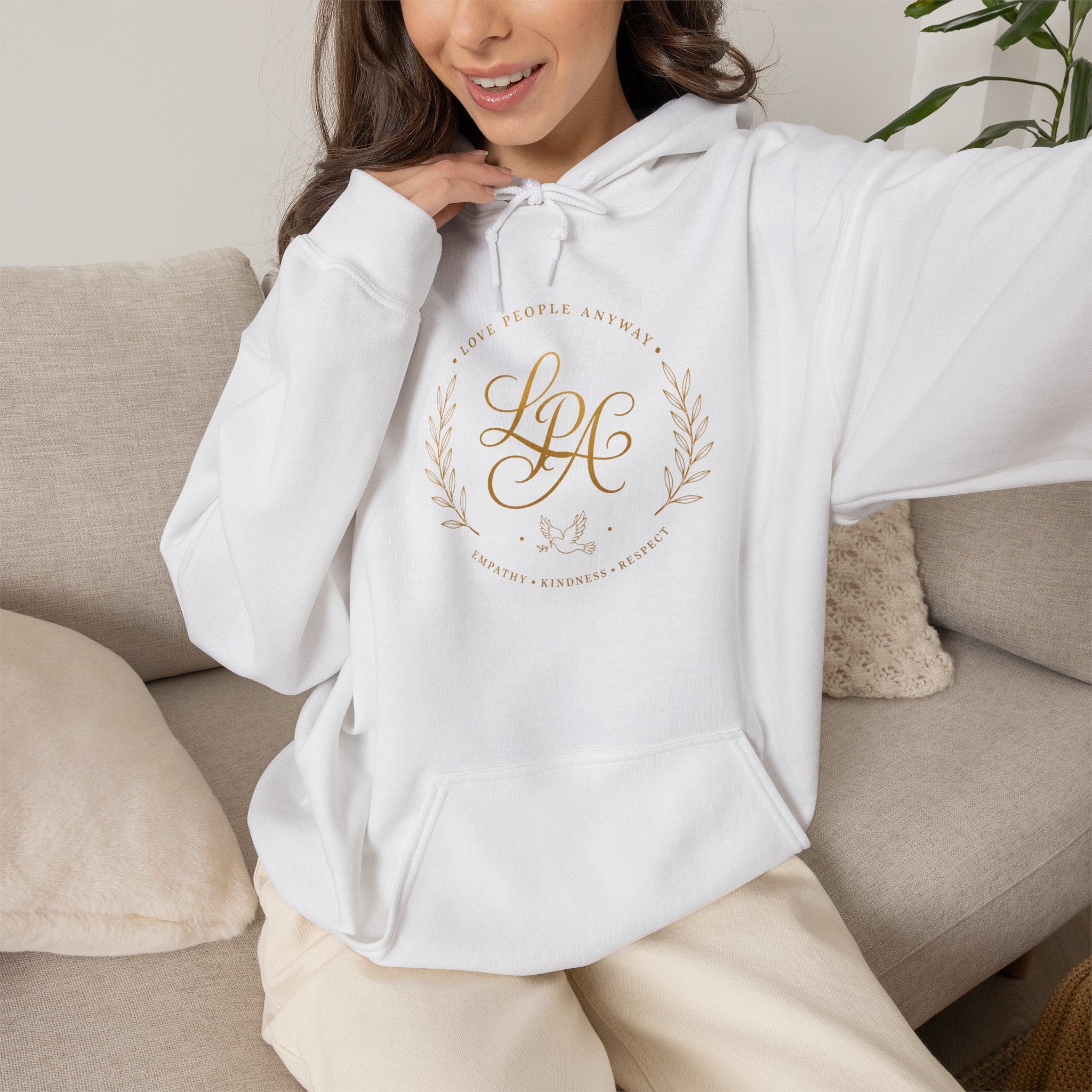 Inspirational Christian hoodie featuring elegant “Love People Anyway” script typography on a soft, cozy hooded sweatshirt designed to encourage kindness and compassion.