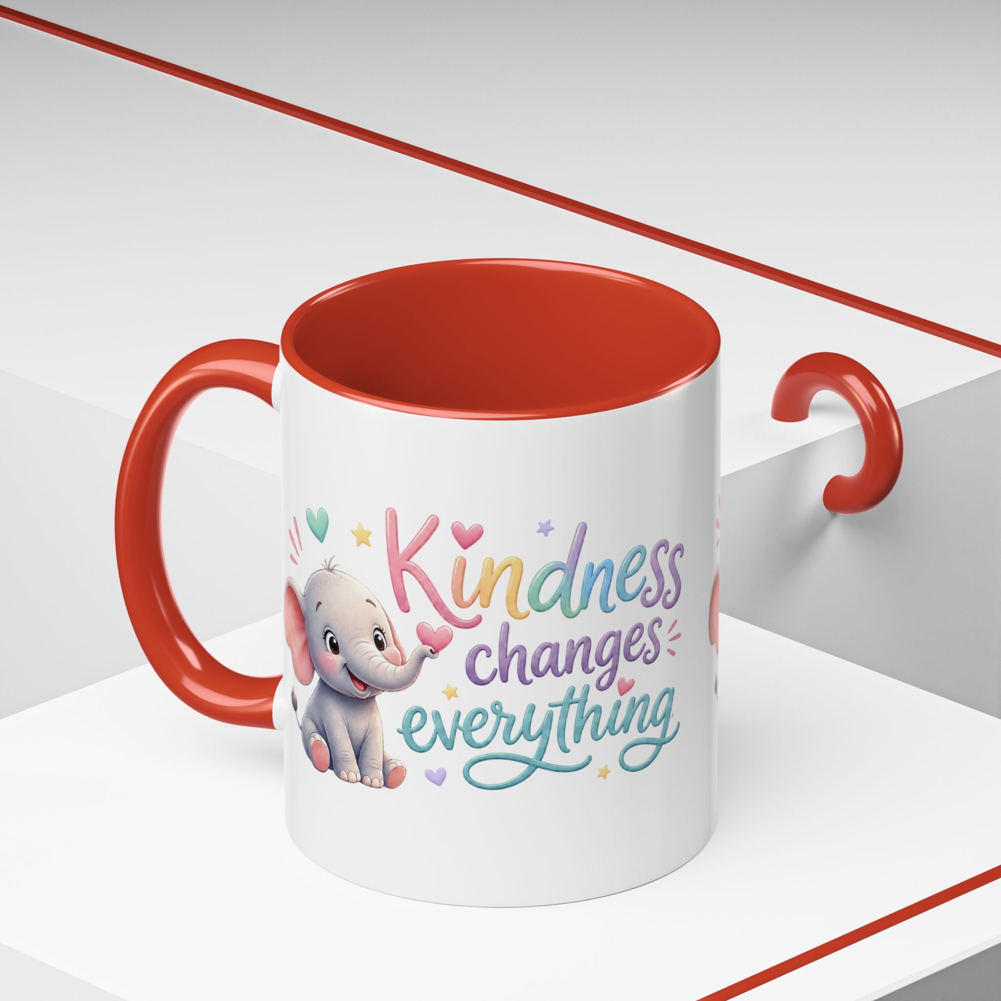 Cute ceramic coffee mug featuring a pastel baby elephant and the uplifting message “Kindness Changes Everything” with colorful accent handle and interior.