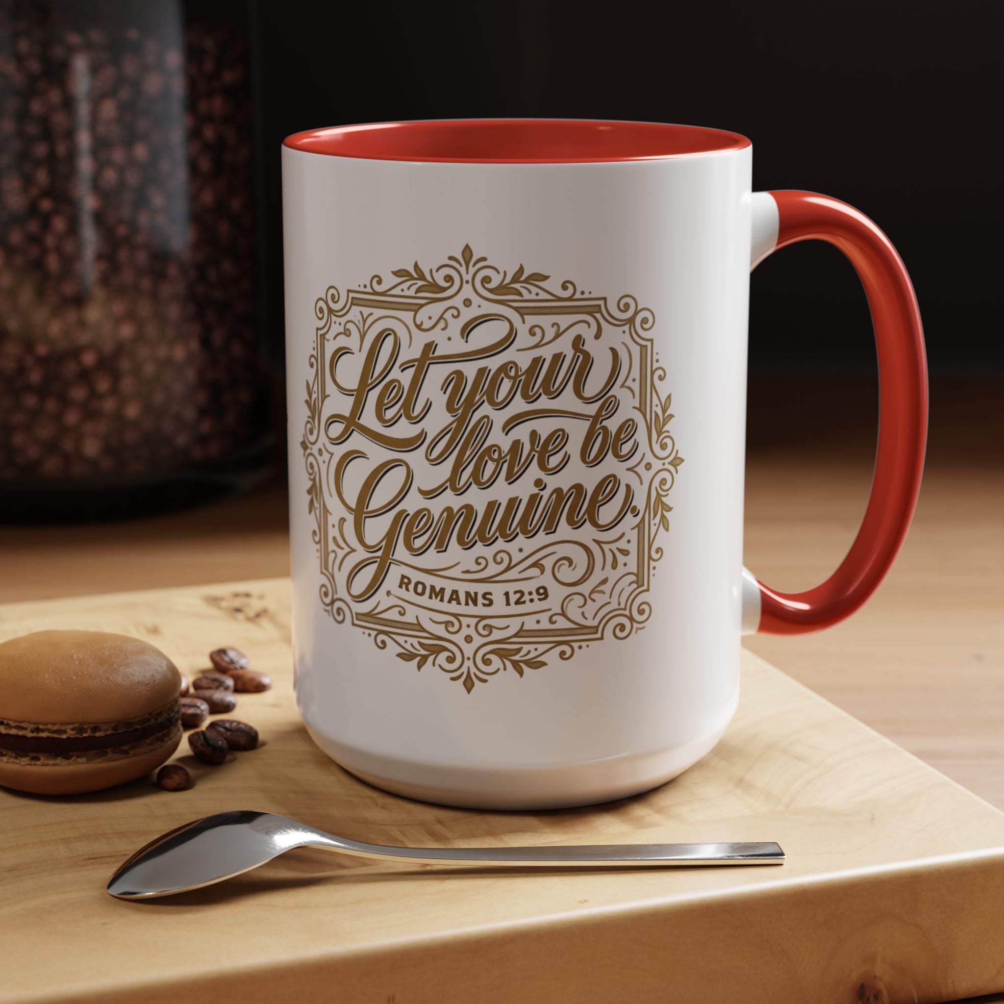 Inspirational ceramic accent coffee mug featuring Romans 12:9 and the message “Let Your Love Be Genuine” in elegant gold script with decorative flourishes and black accent handle and interior.