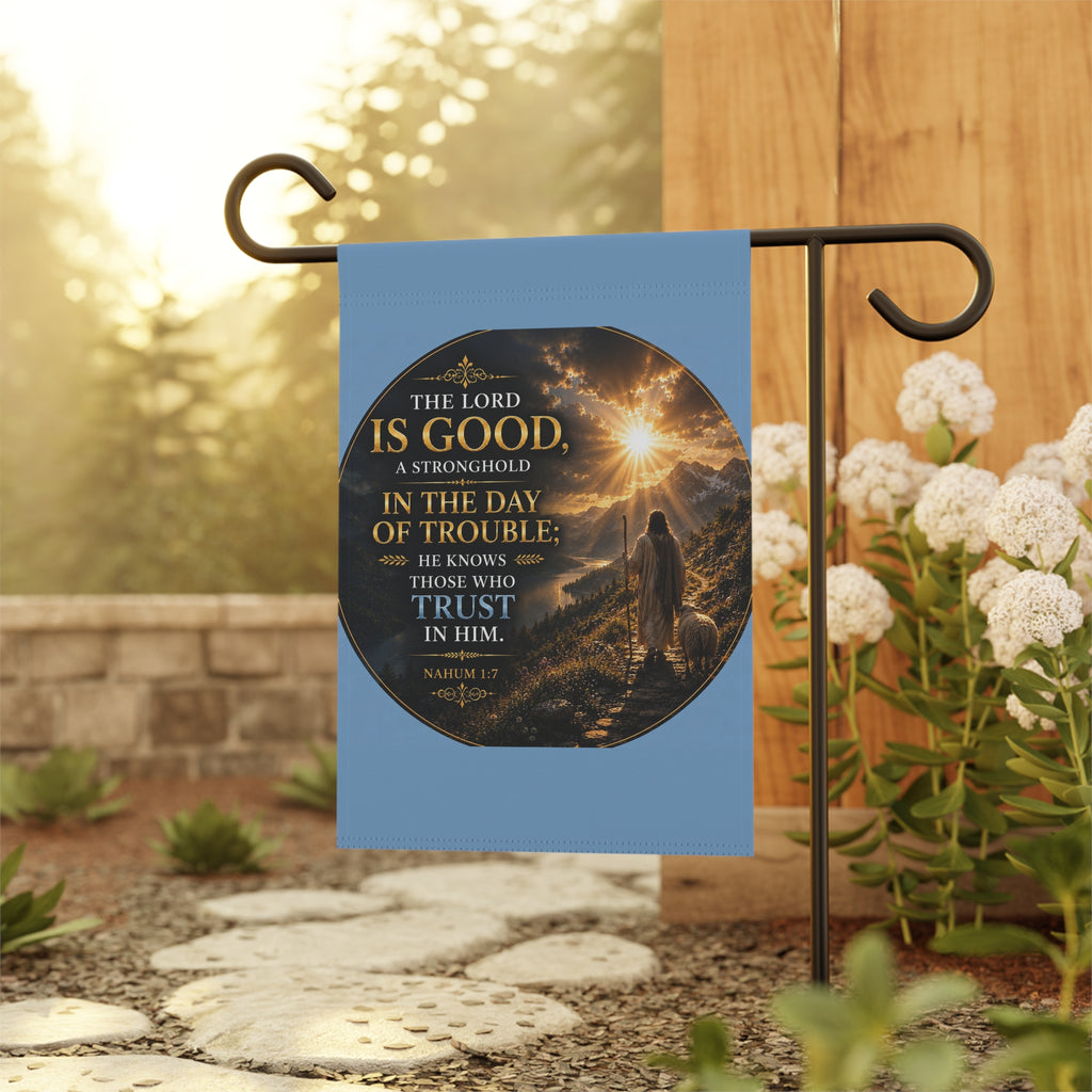 Inspirational Christian garden flag featuring a sunrise pathway scene with a lone figure walking toward golden light and “The Lord Is Good” scripture artwork.