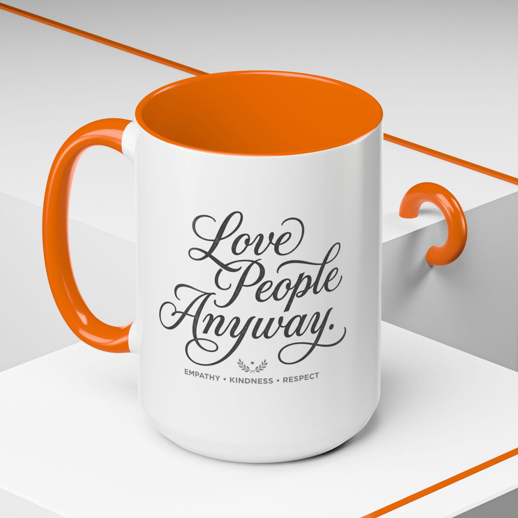 Inspirational ceramic accent coffee mug featuring hand-lettered “Love People Anyway” typography with empathy, kindness, and respect message on a glossy white mug with colorful handle and interior.