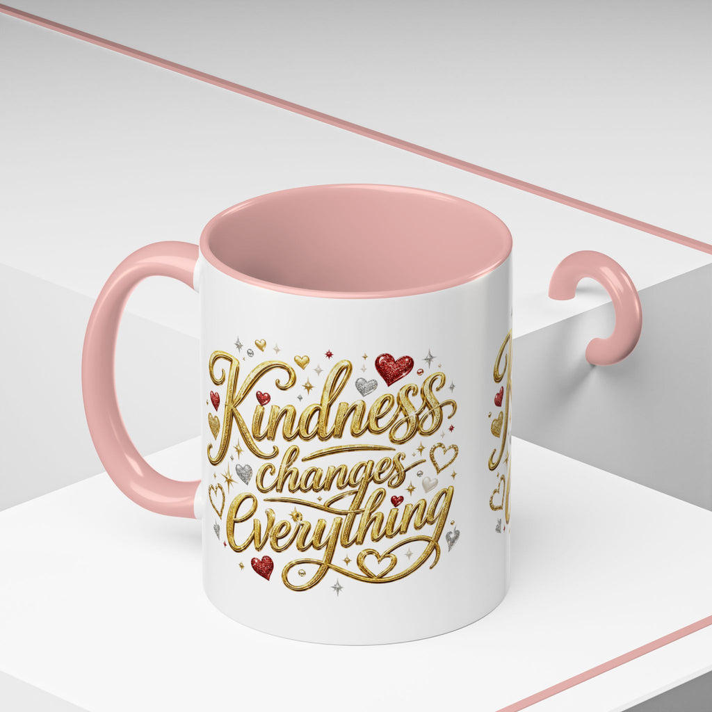 Inspirational ceramic coffee mug featuring the hand-lettered message “Kindness Changes Everything” with gold flourishes, hearts, and colorful accent handle and interior.