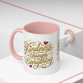 Inspirational ceramic coffee mug featuring the hand-lettered message “Kindness Changes Everything” with gold flourishes, hearts, and colorful accent handle and interior.