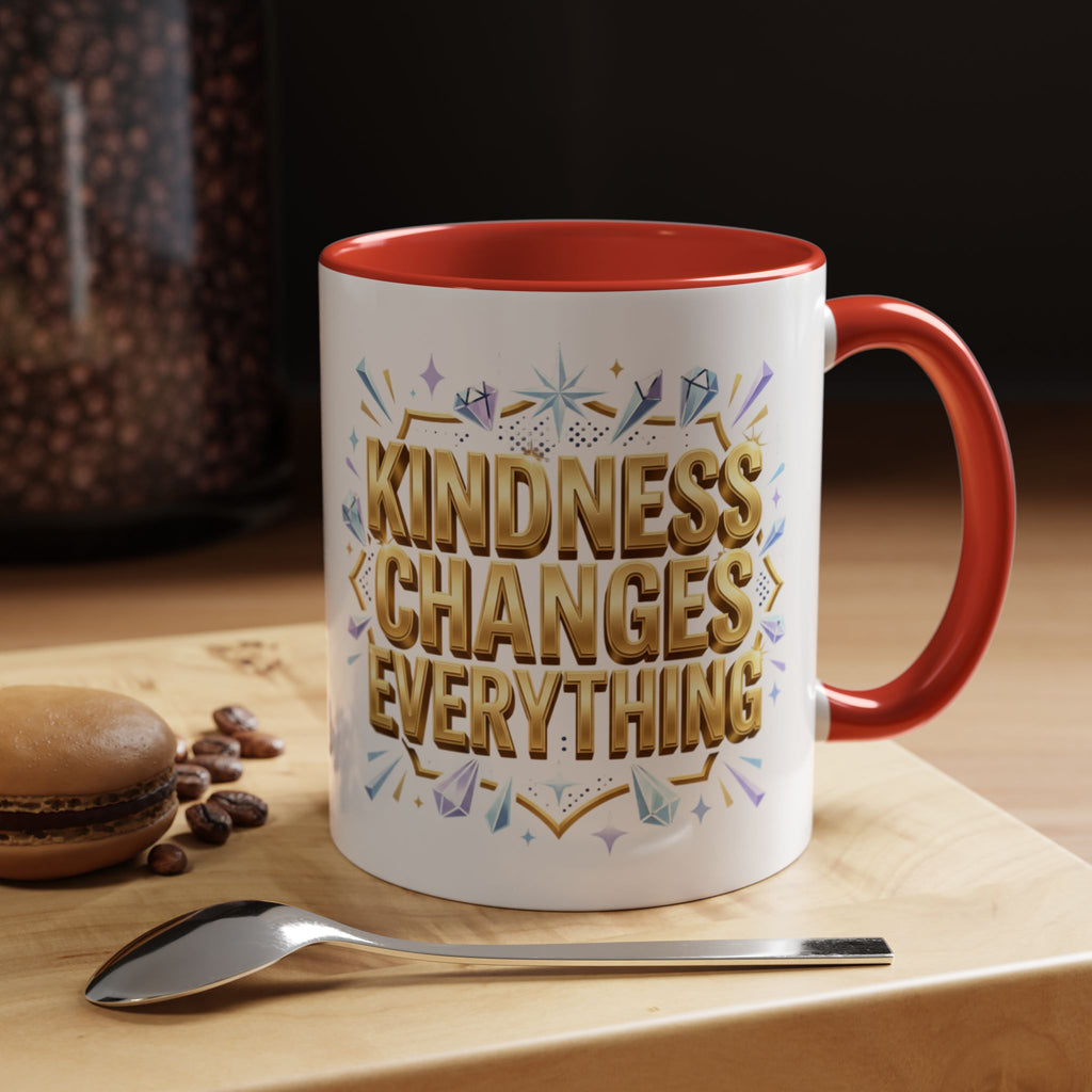 Inspirational ceramic accent coffee mug featuring “Kindness Changes Everything” in elegant gold script with sparkles and colorful accent handle and interior.