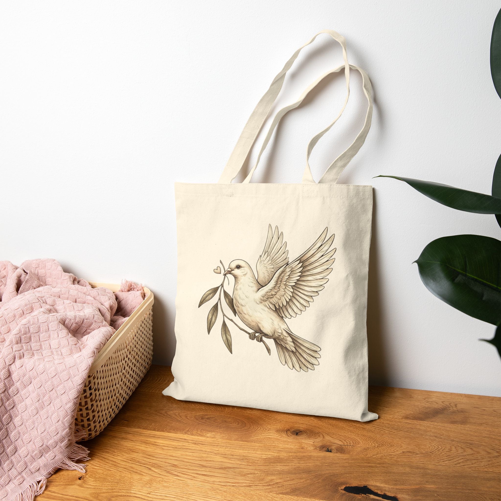 Cotton canvas tote bag featuring a vintage-style dove carrying an olive branch, symbolizing peace, hope, faith, and renewal in a rustic black-and-cream design.