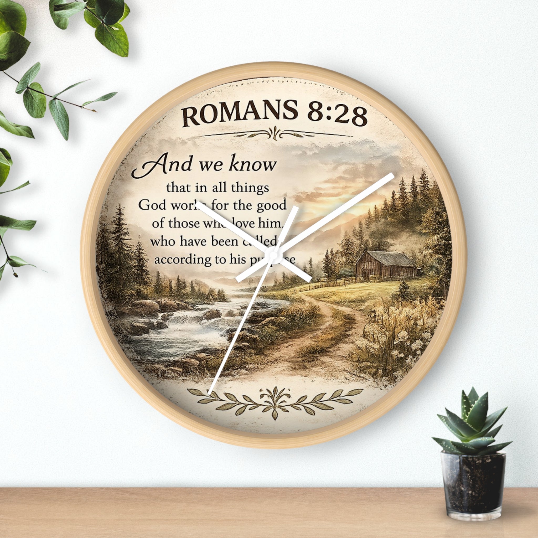 Inspirational Christian wall clock featuring Romans 8:28 scripture with a rustic cabin, flowing creek, and sunset landscape in warm countryside colors.