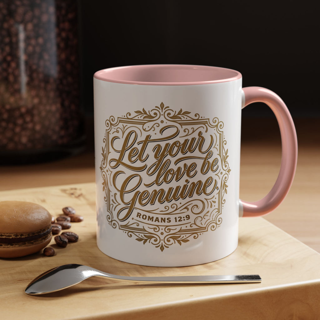 Inspirational ceramic accent coffee mug featuring Romans 12:9 and the message “Let Your Love Be Genuine” in elegant gold script with decorative flourishes and black accent handle and interior.