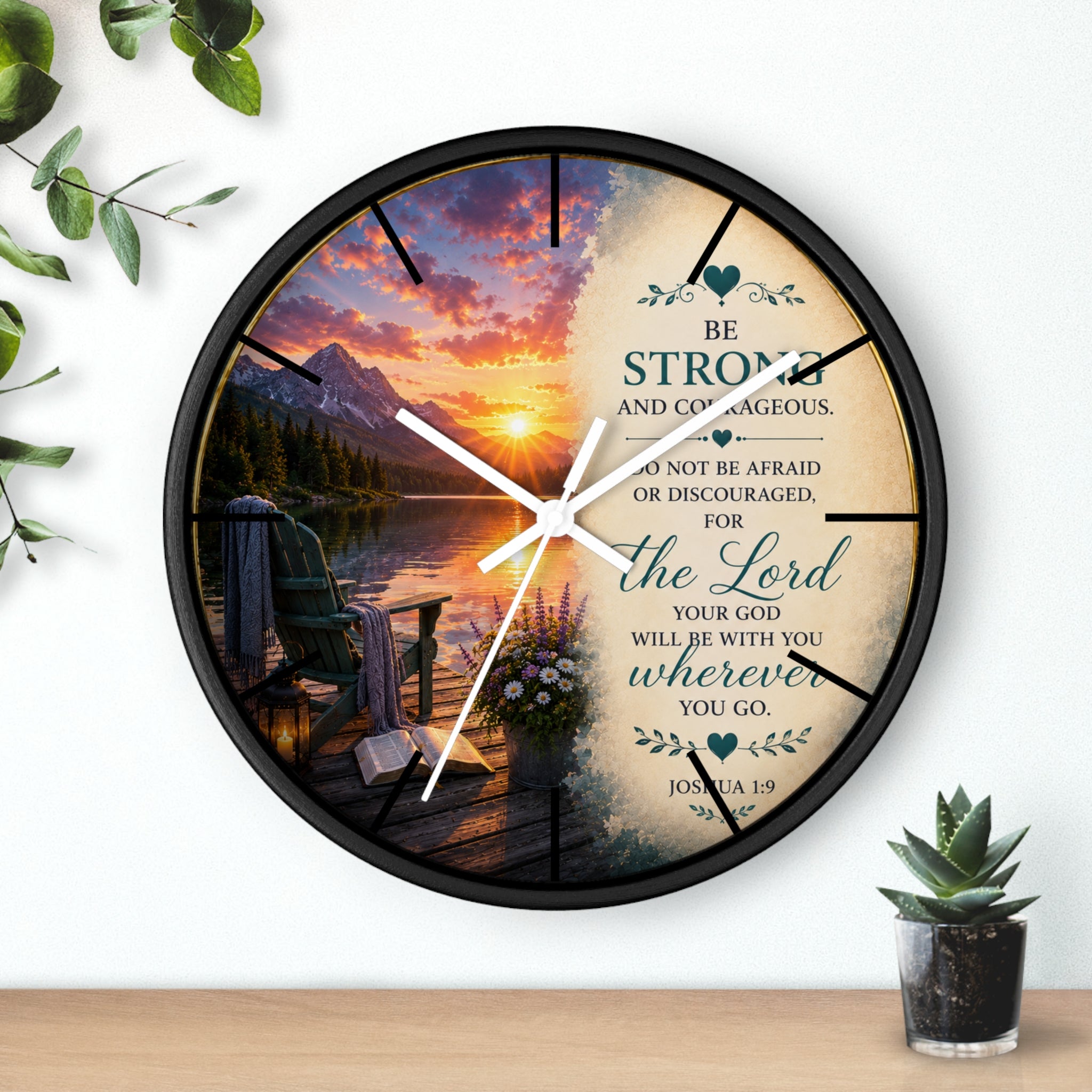 Inspirational Christian wall clock featuring a peaceful lakeside sunrise, mountain scenery, and Joshua 1:9 scripture encouraging strength and courage.