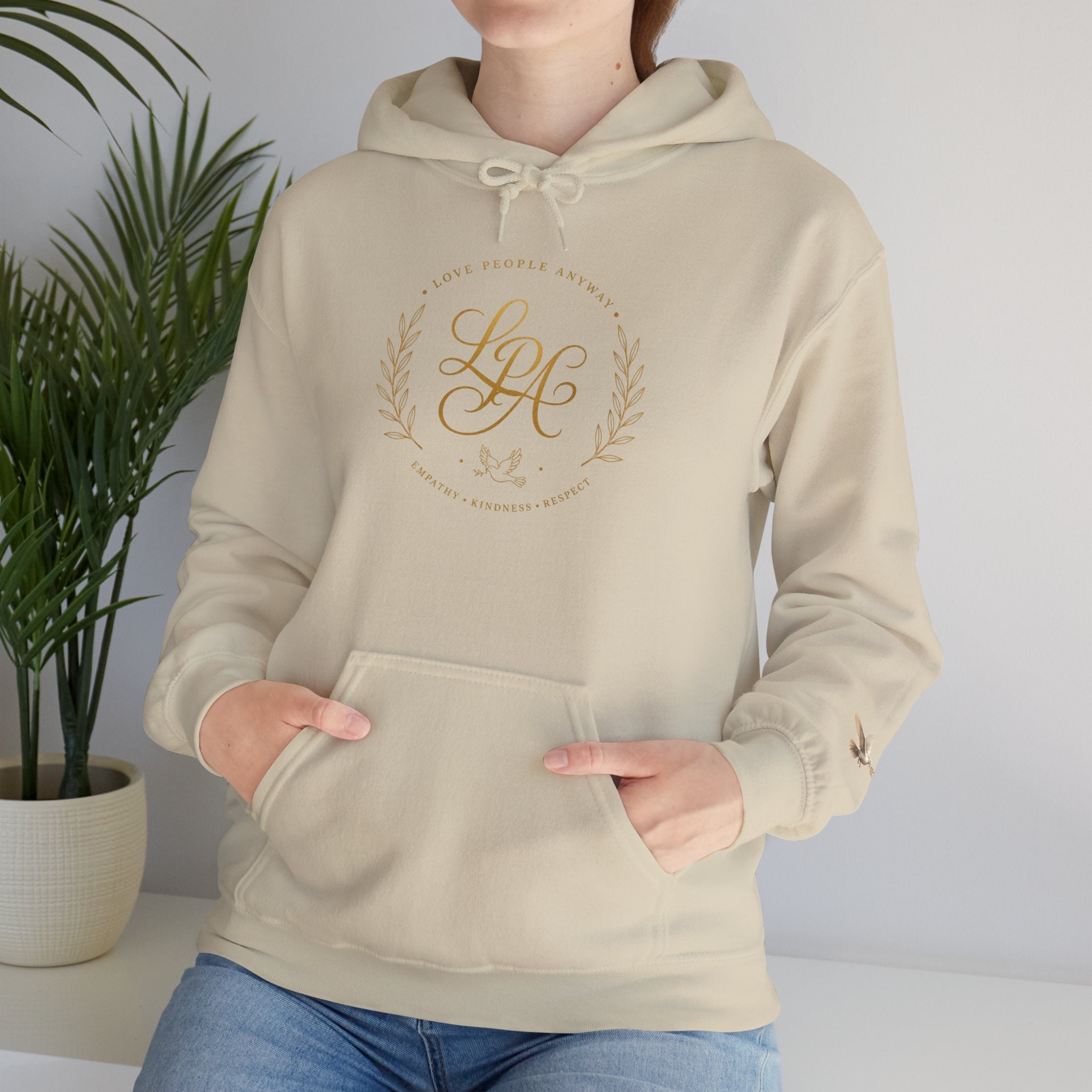Inspirational Christian hoodie featuring elegant “Love People Anyway” script typography on a soft, cozy hooded sweatshirt designed to encourage kindness and compassion.