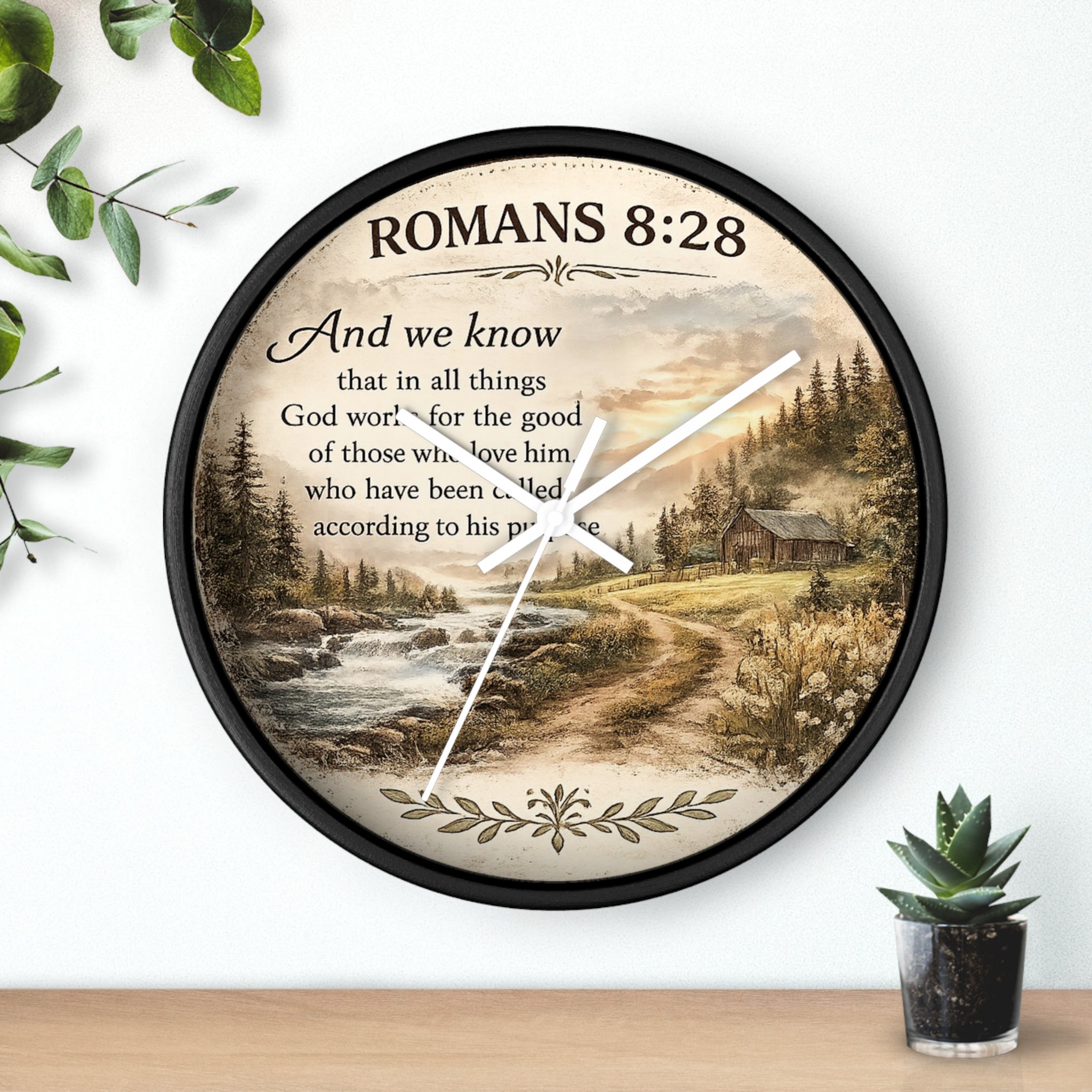 Inspirational Christian wall clock featuring Romans 8:28 scripture with a rustic cabin, flowing creek, and sunset landscape in warm countryside colors.