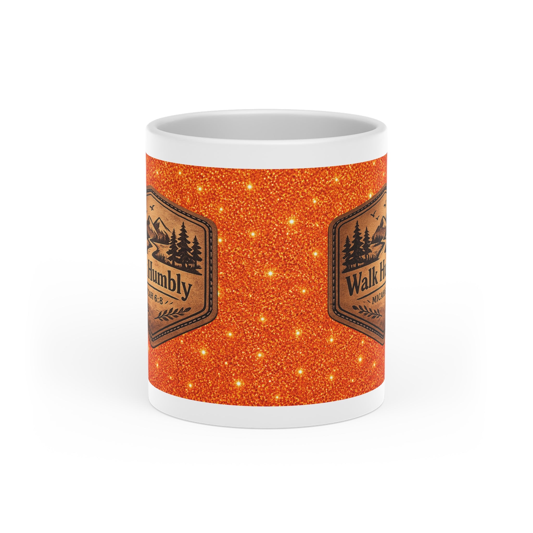 White ceramic heart-shaped handle mug featuring a rustic mountain "Walk Humbly" badge inspired by Micah 6:8 on a sparkling orange background.