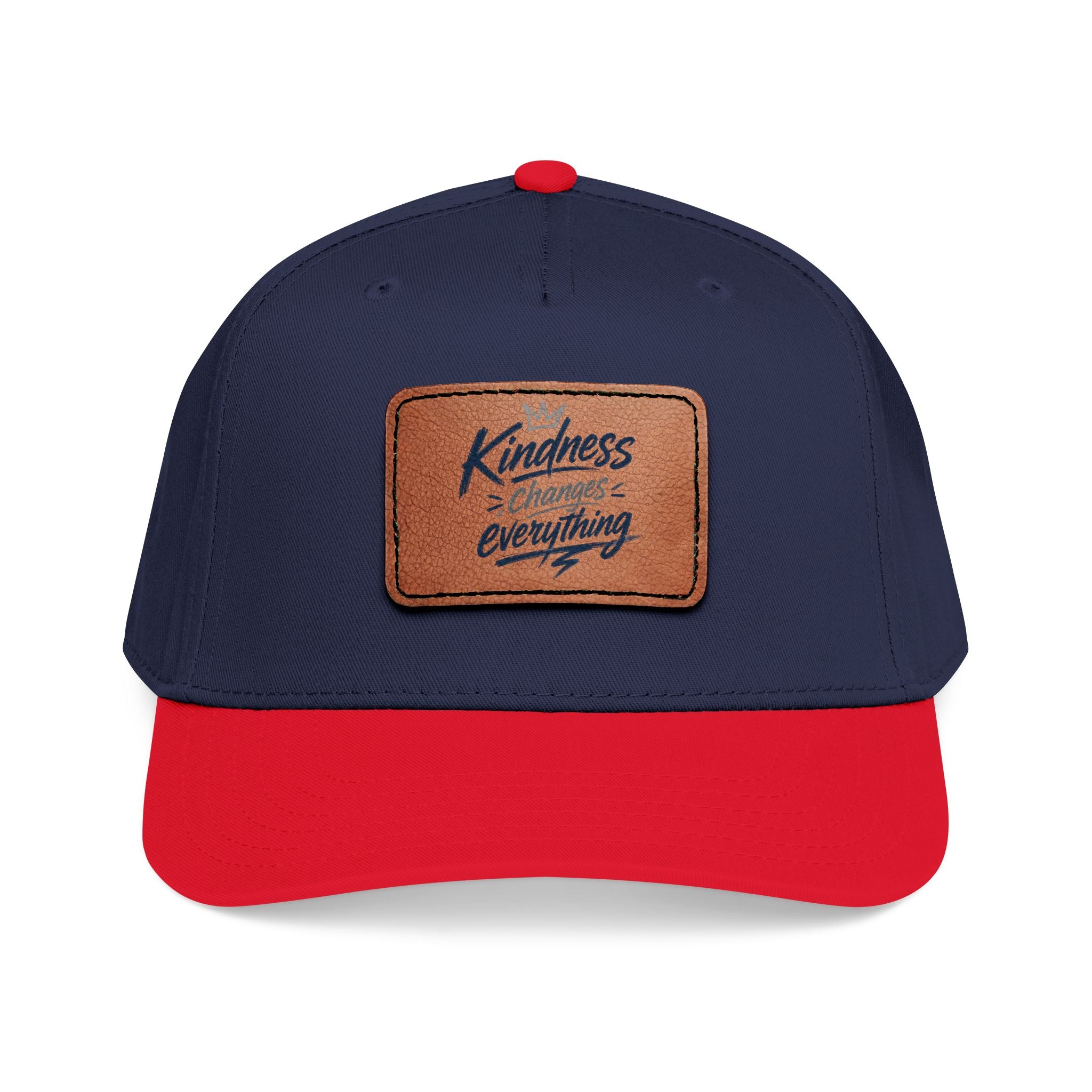 Vintage-inspired baseball cap featuring a brown leather patch with the phrase “Kindness Changes Everything” on a structured mid-profile snapback hat.