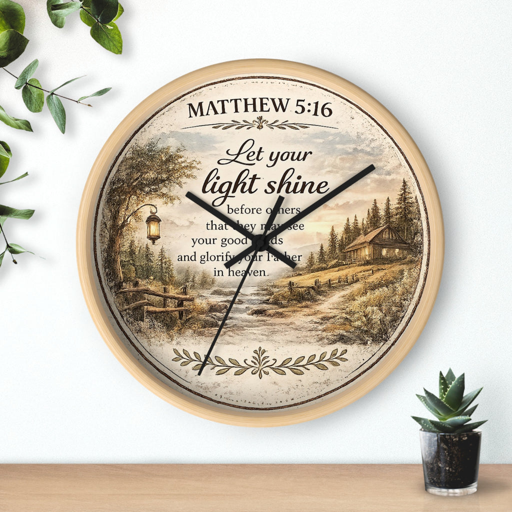 Inspirational Christian wall clock featuring Matthew 5:16 with a lantern-lit path, pine trees, rustic cottage, and warm countryside artwork in vintage farmhouse style.