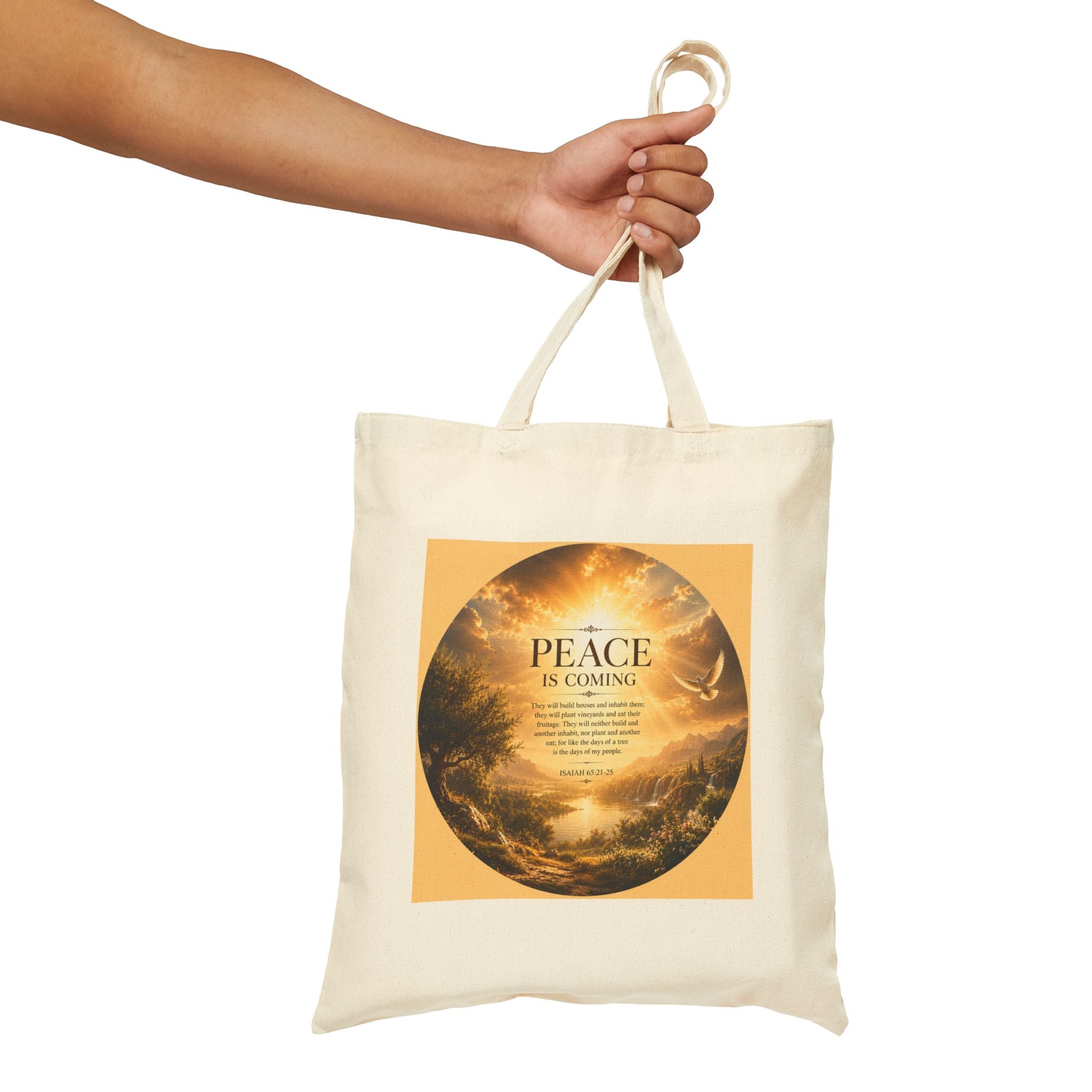Christian cotton canvas tote bag featuring Isaiah 65:21-25 and the message “Peace Is Coming,” with golden paradise landscape artwork, waterfalls, mountains, river, white dove, and radiant sunlight.