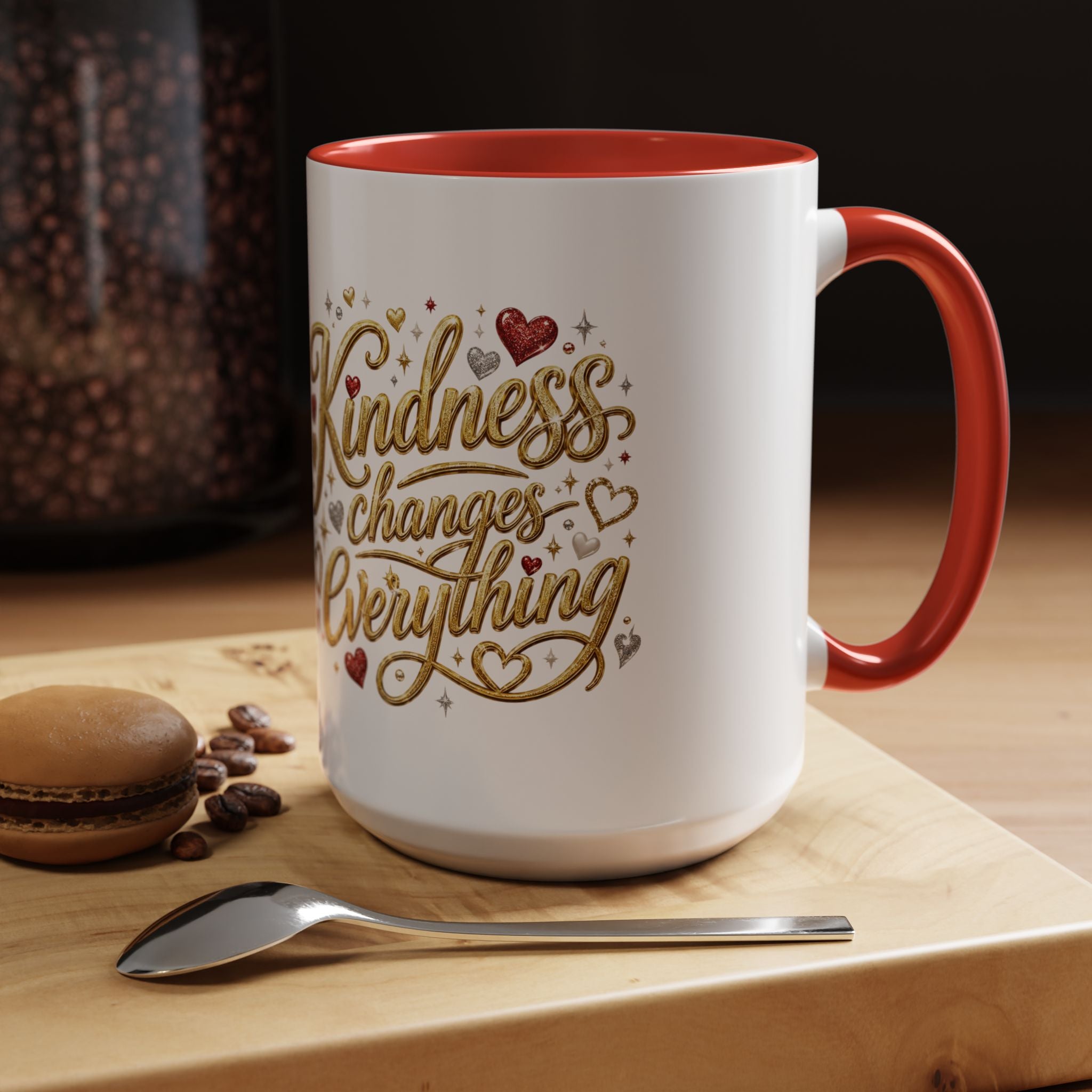 Inspirational ceramic coffee mug featuring the hand-lettered message “Kindness Changes Everything” with gold flourishes, hearts, and colorful accent handle and interior.