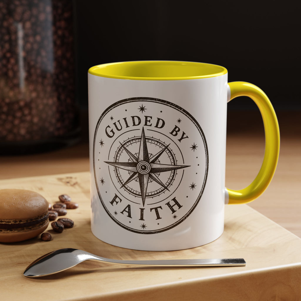 Inspirational ceramic accent coffee mug featuring a compass design and “Guided by Faith” message with colorful handle and interior accents on a glossy white mug.