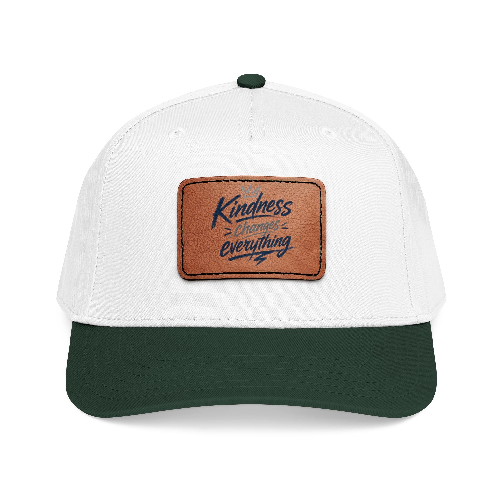 Vintage-inspired baseball cap featuring a brown leather patch with the phrase “Kindness Changes Everything” on a structured mid-profile snapback hat.