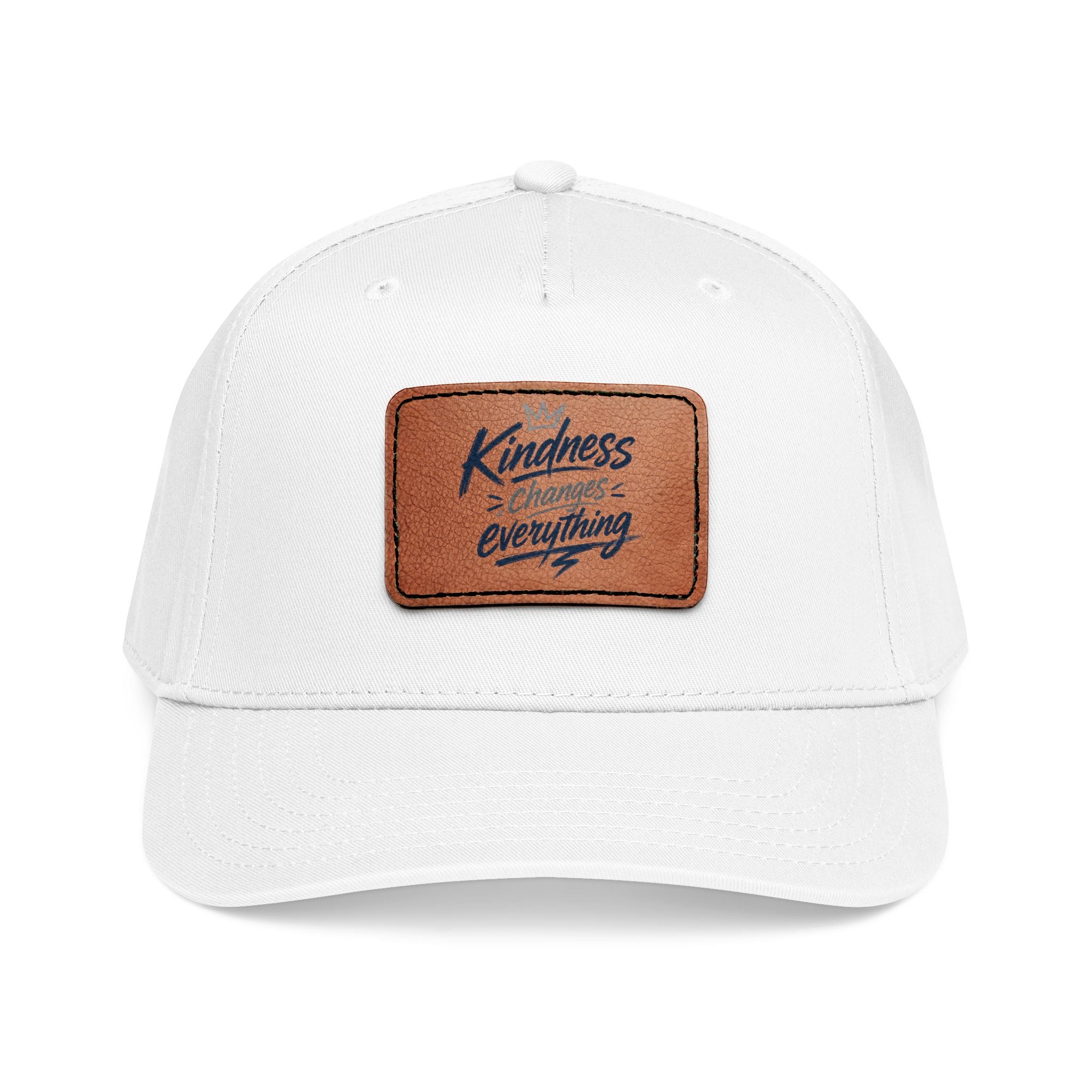 Vintage-inspired baseball cap featuring a brown leather patch with the phrase “Kindness Changes Everything” on a structured mid-profile snapback hat.