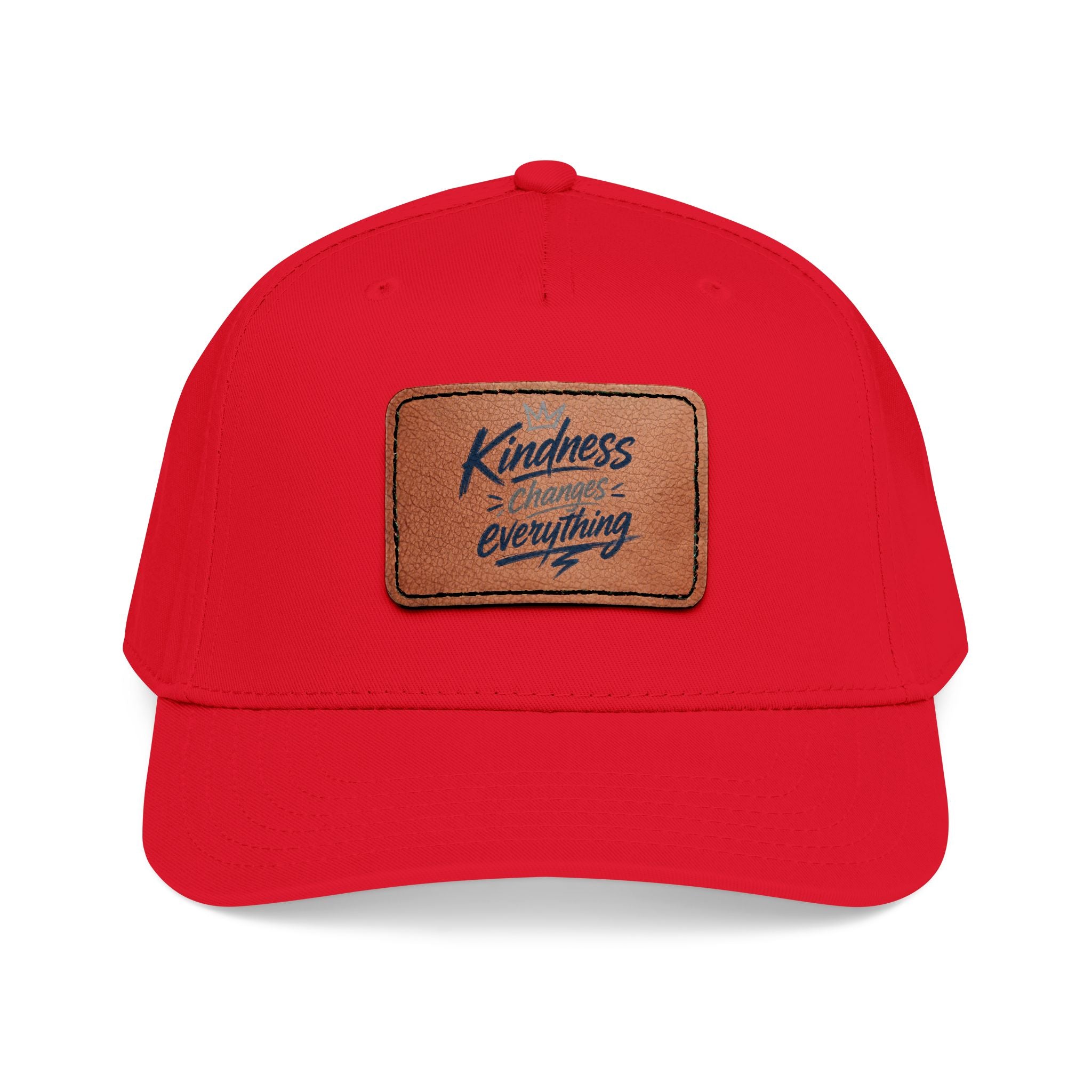 Vintage-inspired baseball cap featuring a brown leather patch with the phrase “Kindness Changes Everything” on a structured mid-profile snapback hat.