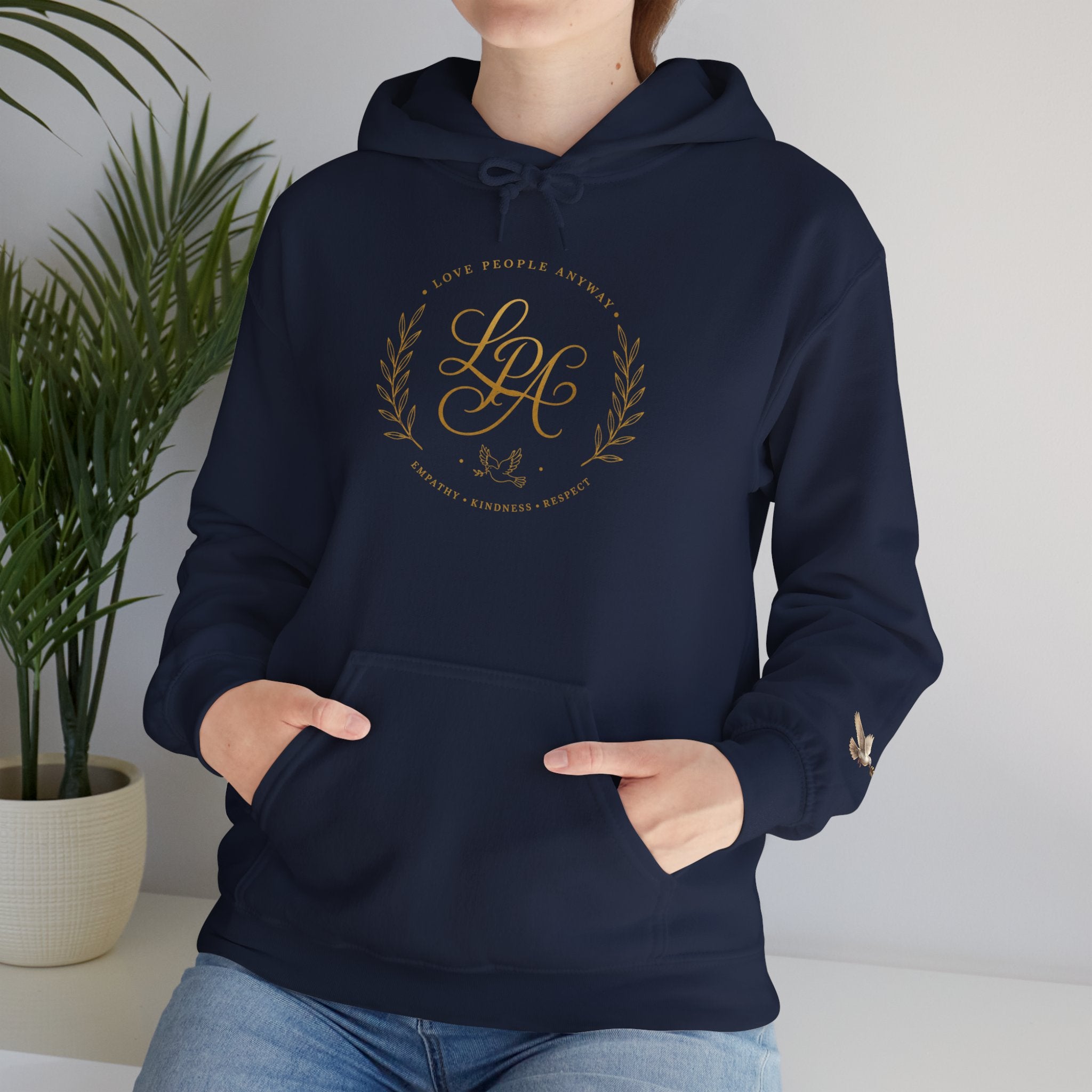 Inspirational Christian hoodie featuring elegant “Love People Anyway” script typography on a soft, cozy hooded sweatshirt designed to encourage kindness and compassion.