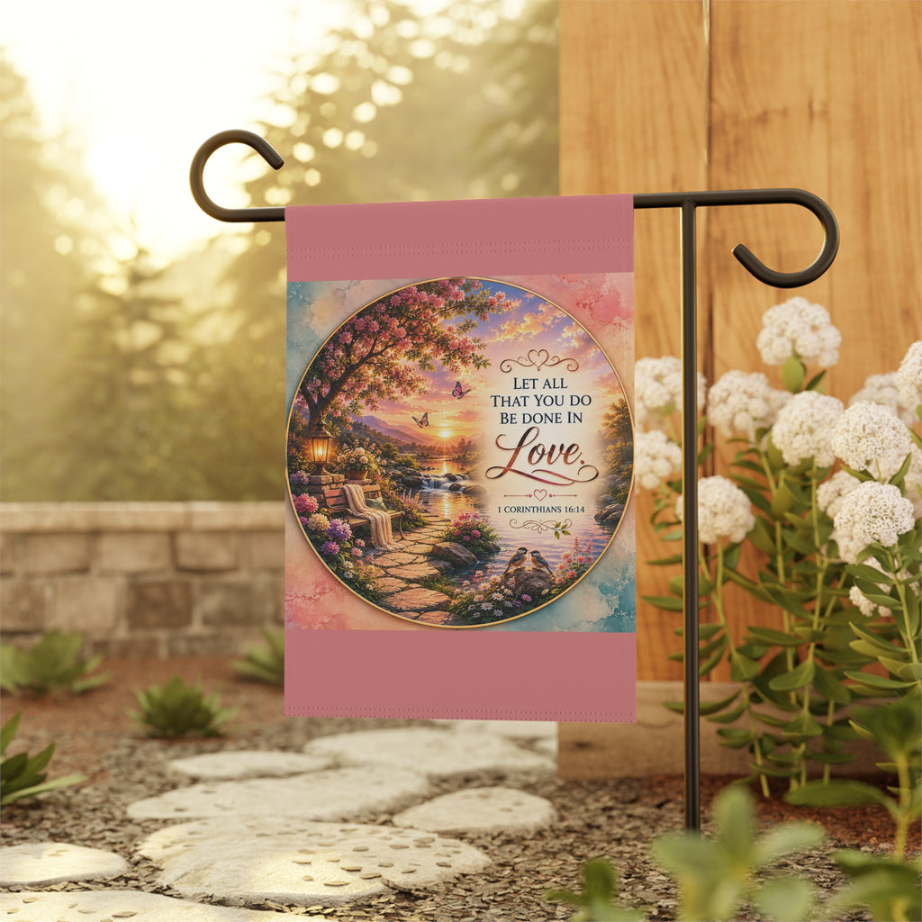 Inspirational Christian garden flag featuring a floral lakeside scene with hydrangeas, a sunlit pathway, and 1 Corinthians 16:14 scripture about love.