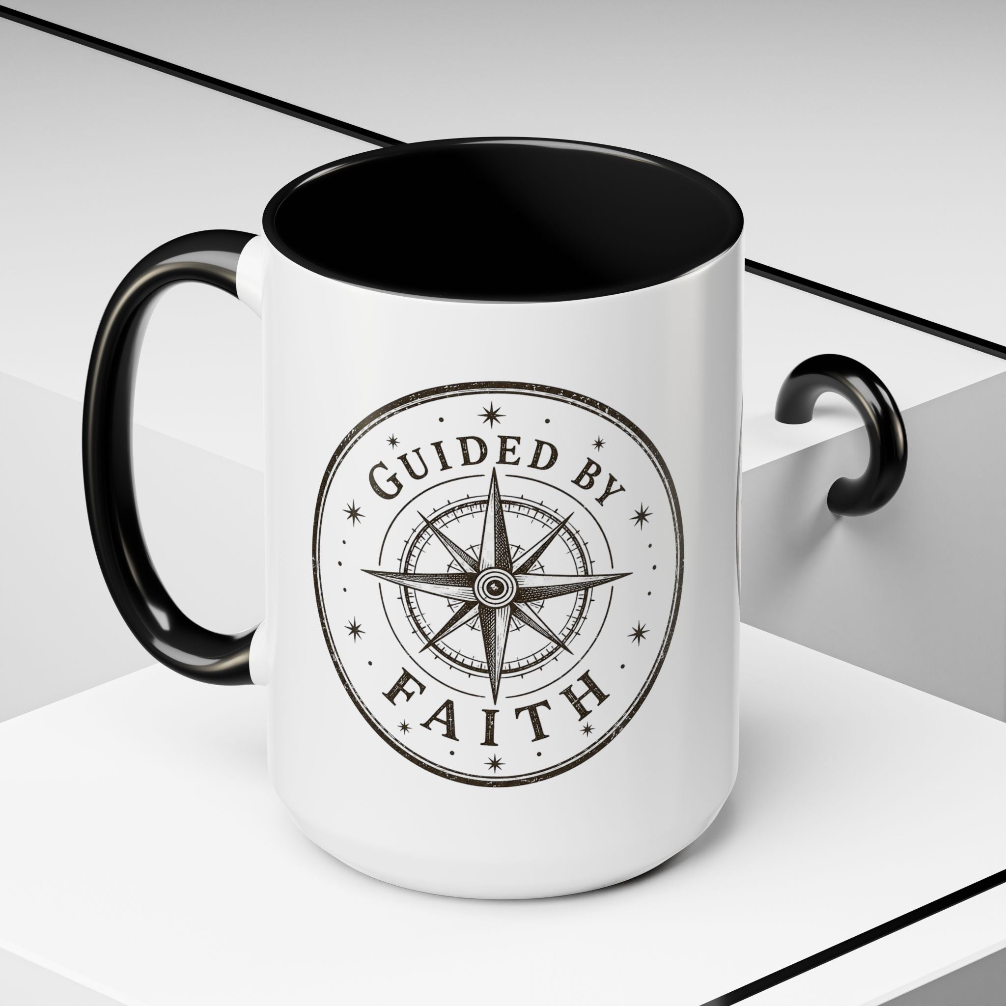Inspirational ceramic accent coffee mug featuring a compass design and “Guided by Faith” message with colorful handle and interior accents on a glossy white mug.