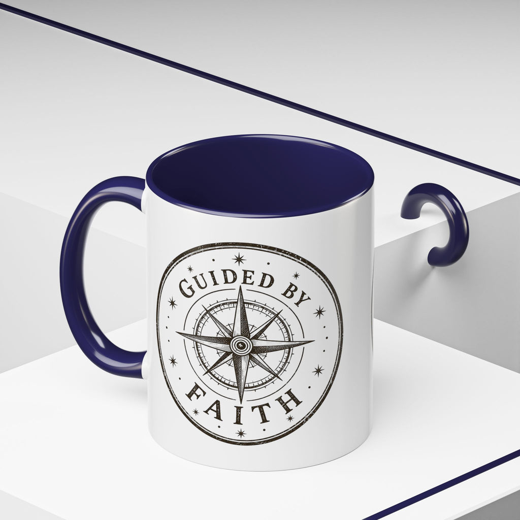 Inspirational ceramic accent coffee mug featuring a compass design and “Guided by Faith” message with colorful handle and interior accents on a glossy white mug.