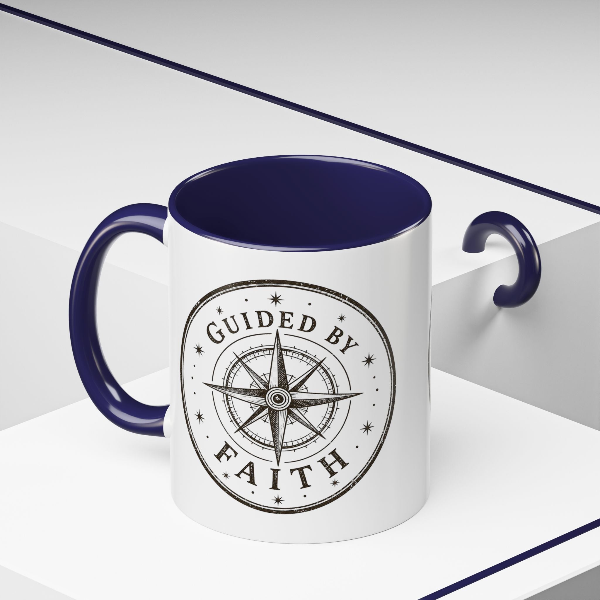 Inspirational ceramic accent coffee mug featuring a compass design and “Guided by Faith” message with colorful handle and interior accents on a glossy white mug.