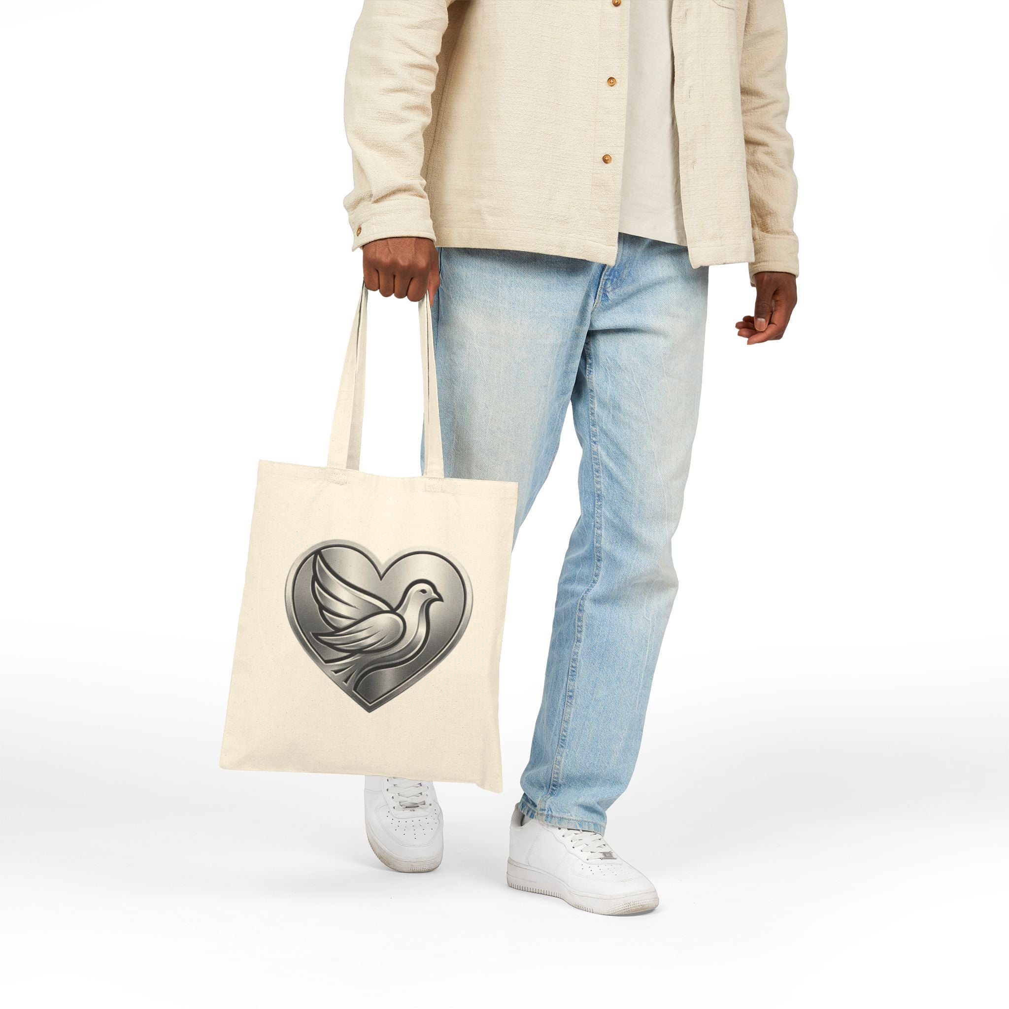 Cotton canvas tote bag featuring a silver dove inside a heart design, symbolizing peace, love, faith, hope, and encouragement in an elegant minimalist style.