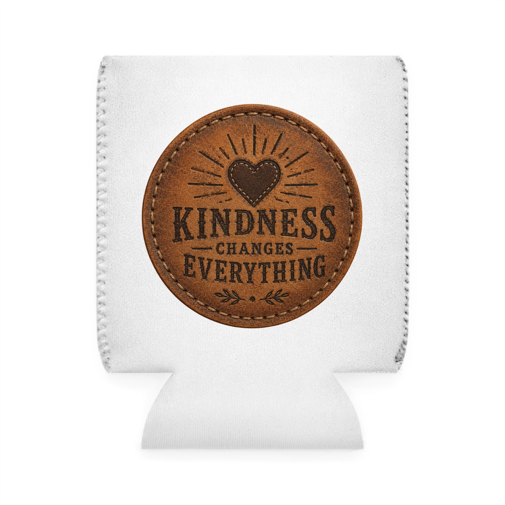 A white fabric can cooler sleeve with a circular brown faux-leather patch on the front that reads 'KINDNESS CHANGES EVERYTHING' with a heart design, shown on a white background.