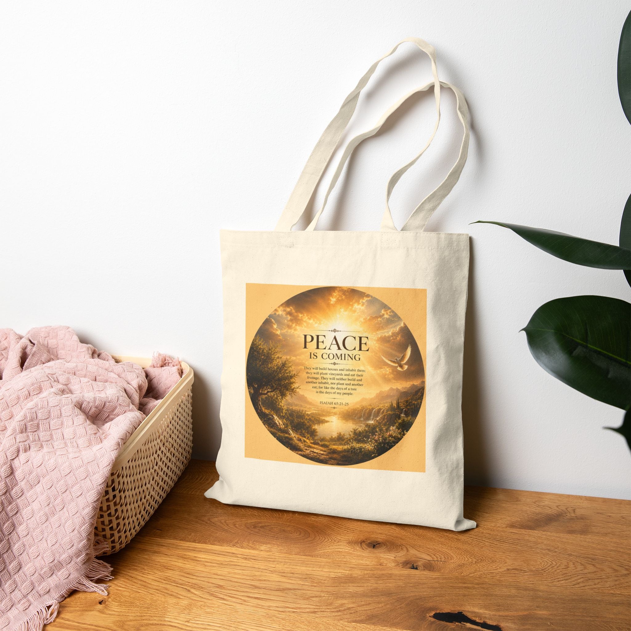 Christian cotton canvas tote bag featuring Isaiah 65:21-25 and the message “Peace Is Coming,” with golden paradise landscape artwork, waterfalls, mountains, river, white dove, and radiant sunlight.