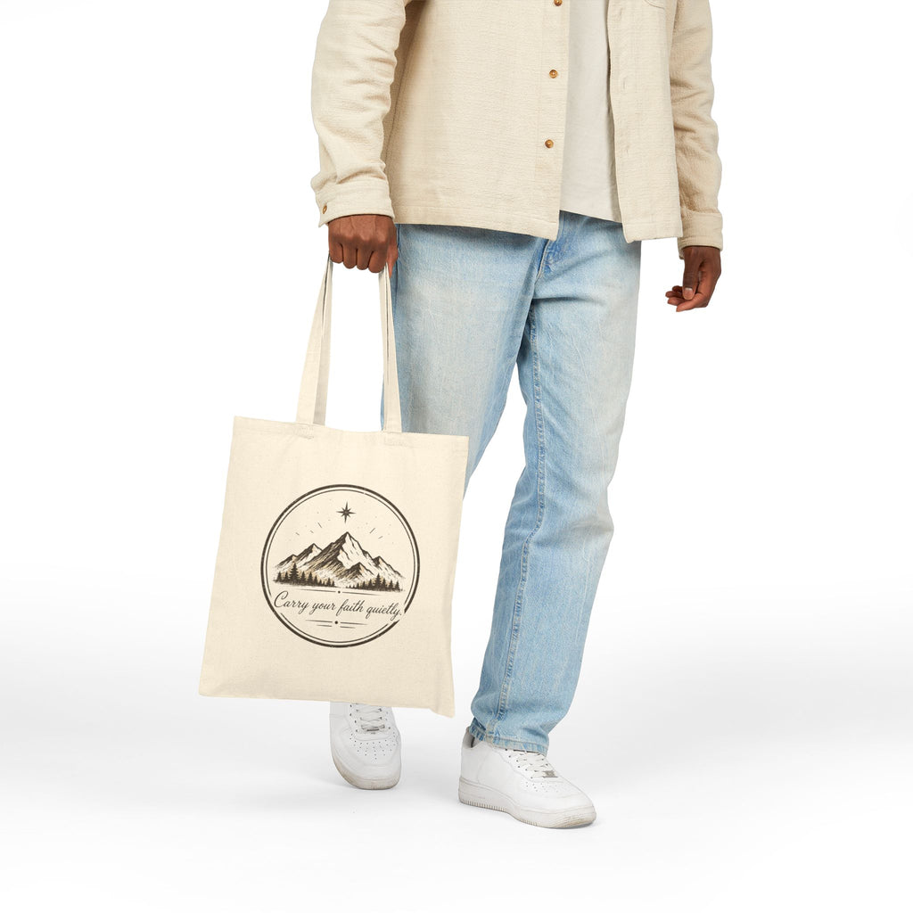 Rustic cotton canvas tote bag featuring mountain peaks, pine trees, a guiding star, and the Faith & Freedom Creations tagline “Carry Your Faith Quietly” in a vintage outdoor-inspired design.