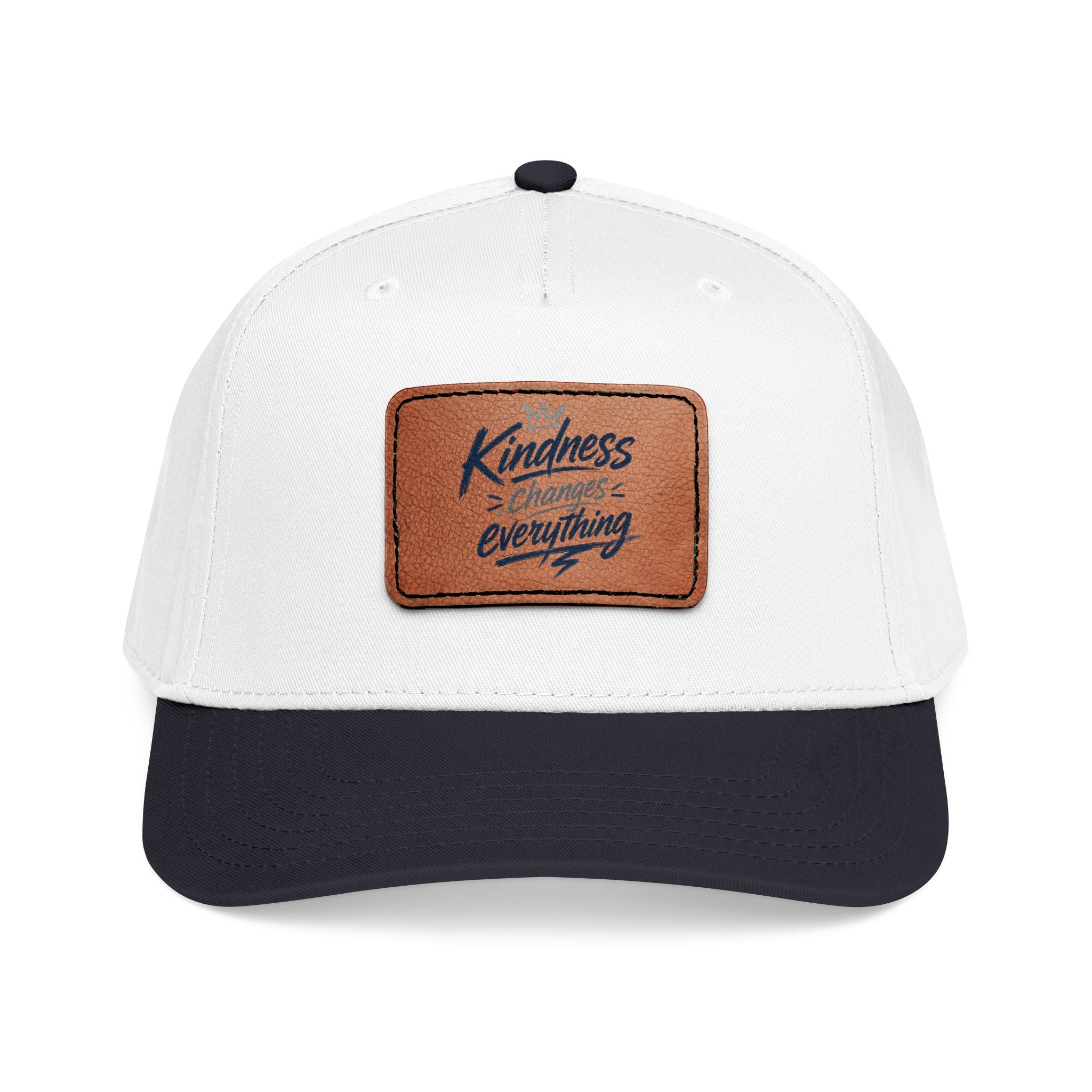 Vintage-inspired baseball cap featuring a brown leather patch with the phrase “Kindness Changes Everything” on a structured mid-profile snapback hat.