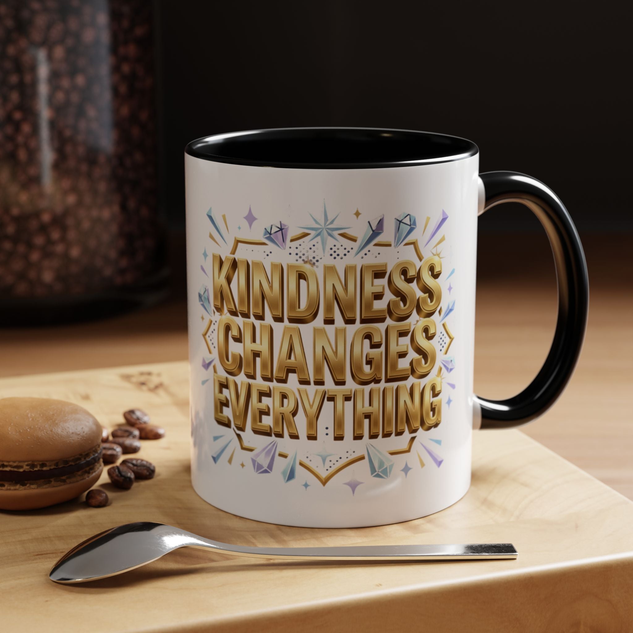 Inspirational ceramic accent coffee mug featuring “Kindness Changes Everything” in elegant gold script with sparkles and colorful accent handle and interior.