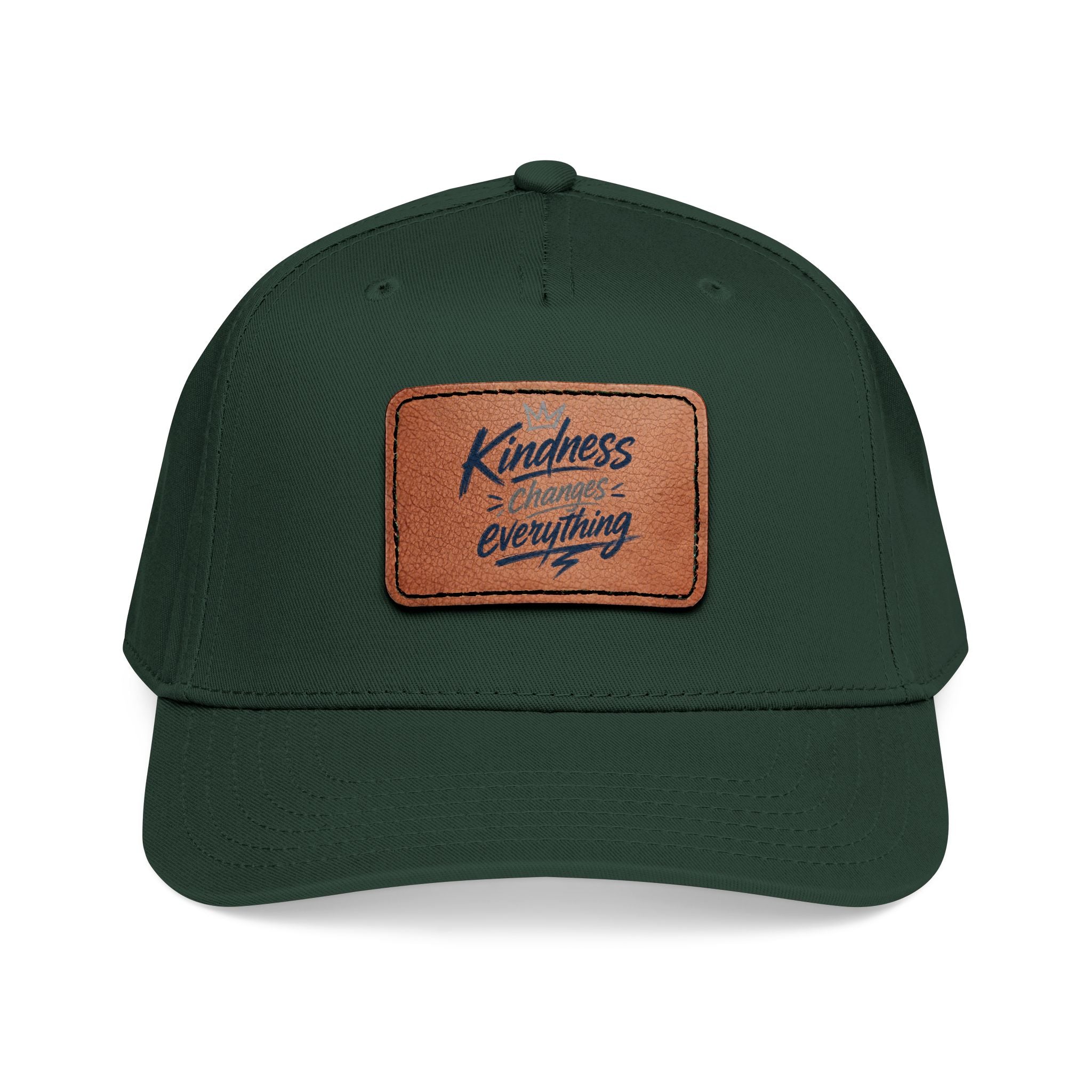 Vintage-inspired baseball cap featuring a brown leather patch with the phrase “Kindness Changes Everything” on a structured mid-profile snapback hat.