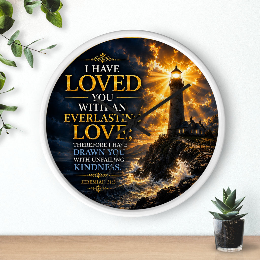 Inspirational Christian wall clock featuring a glowing lighthouse over stormy seas with Jeremiah 31:3 scripture about everlasting love in warm golden tones.