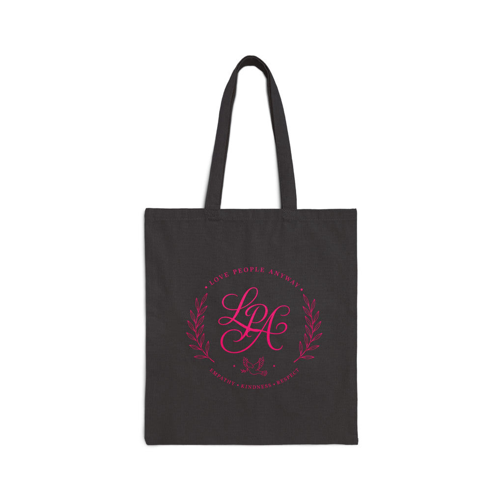 Pink monogram cotton canvas tote bag featuring the message “Love People Anyway,” laurel branches, a dove carrying an olive branch, and the words empathy, kindness, and respect in an elegant boutique design.