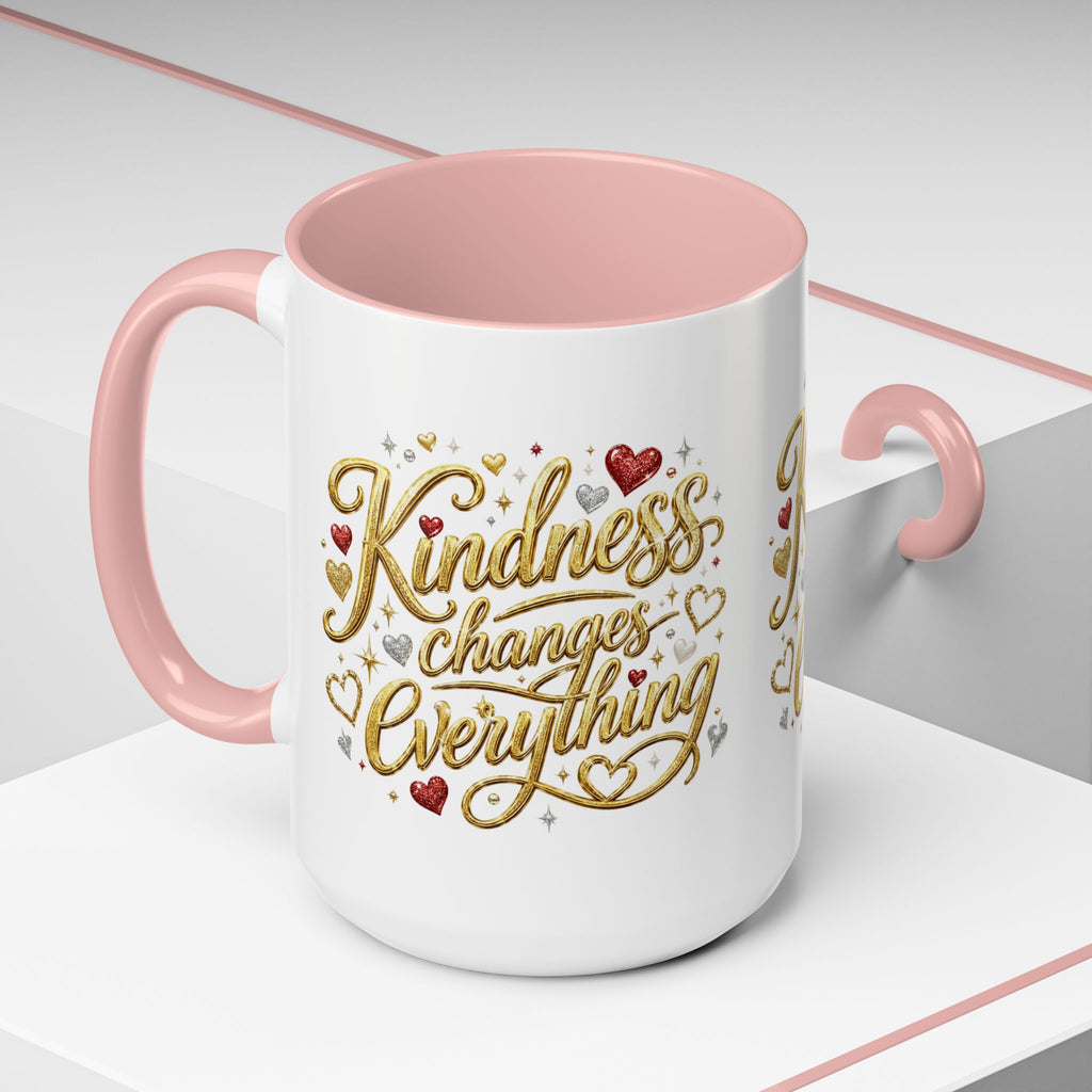 Inspirational ceramic coffee mug featuring the hand-lettered message “Kindness Changes Everything” with gold flourishes, hearts, and colorful accent handle and interior.