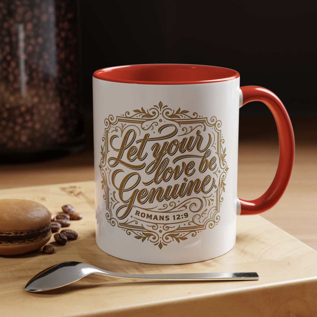 Inspirational ceramic accent coffee mug featuring Romans 12:9 and the message “Let Your Love Be Genuine” in elegant gold script with decorative flourishes and black accent handle and interior.